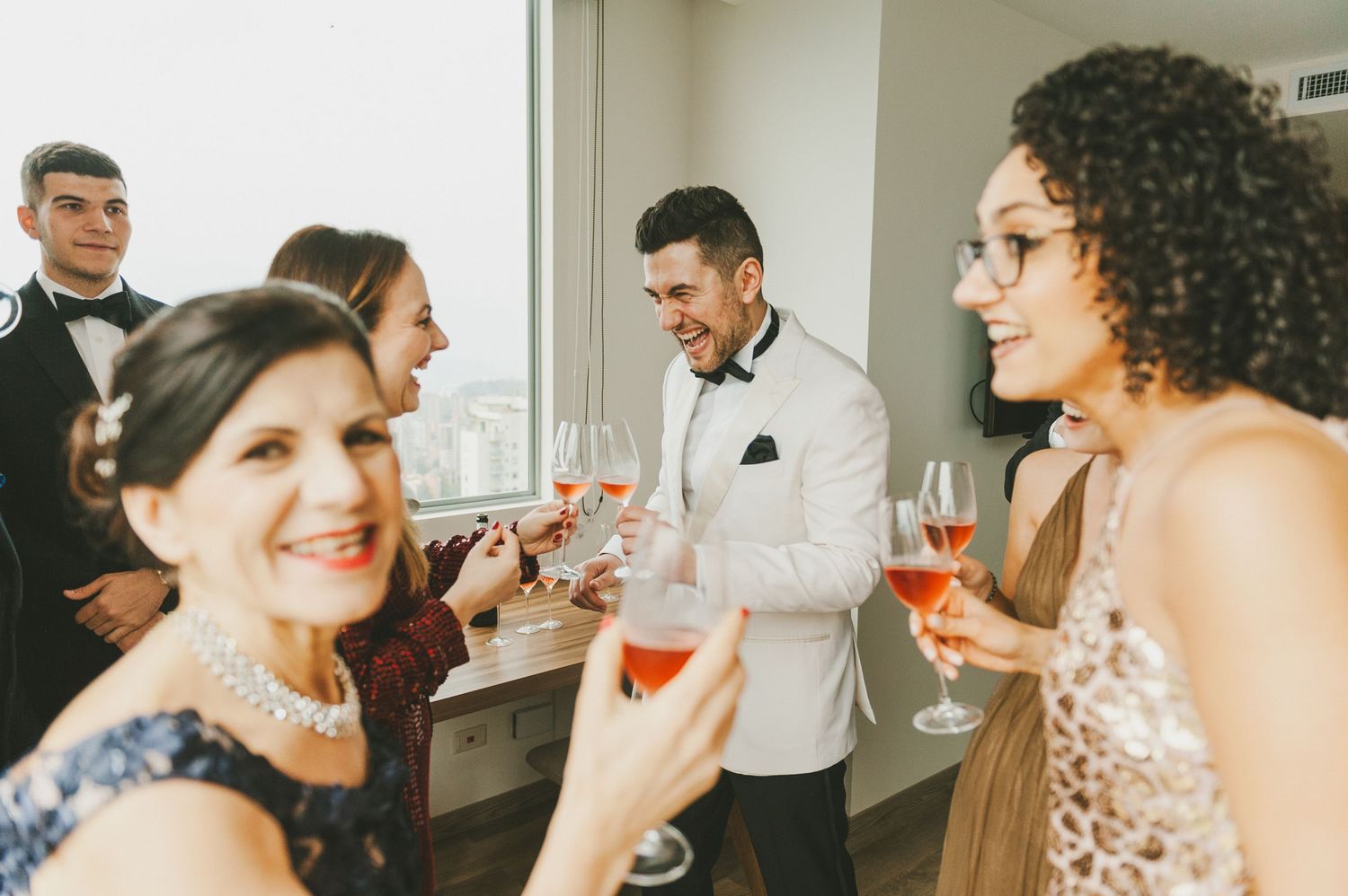 Guests raise champagne glasses for a toast at an elegant celebration party.