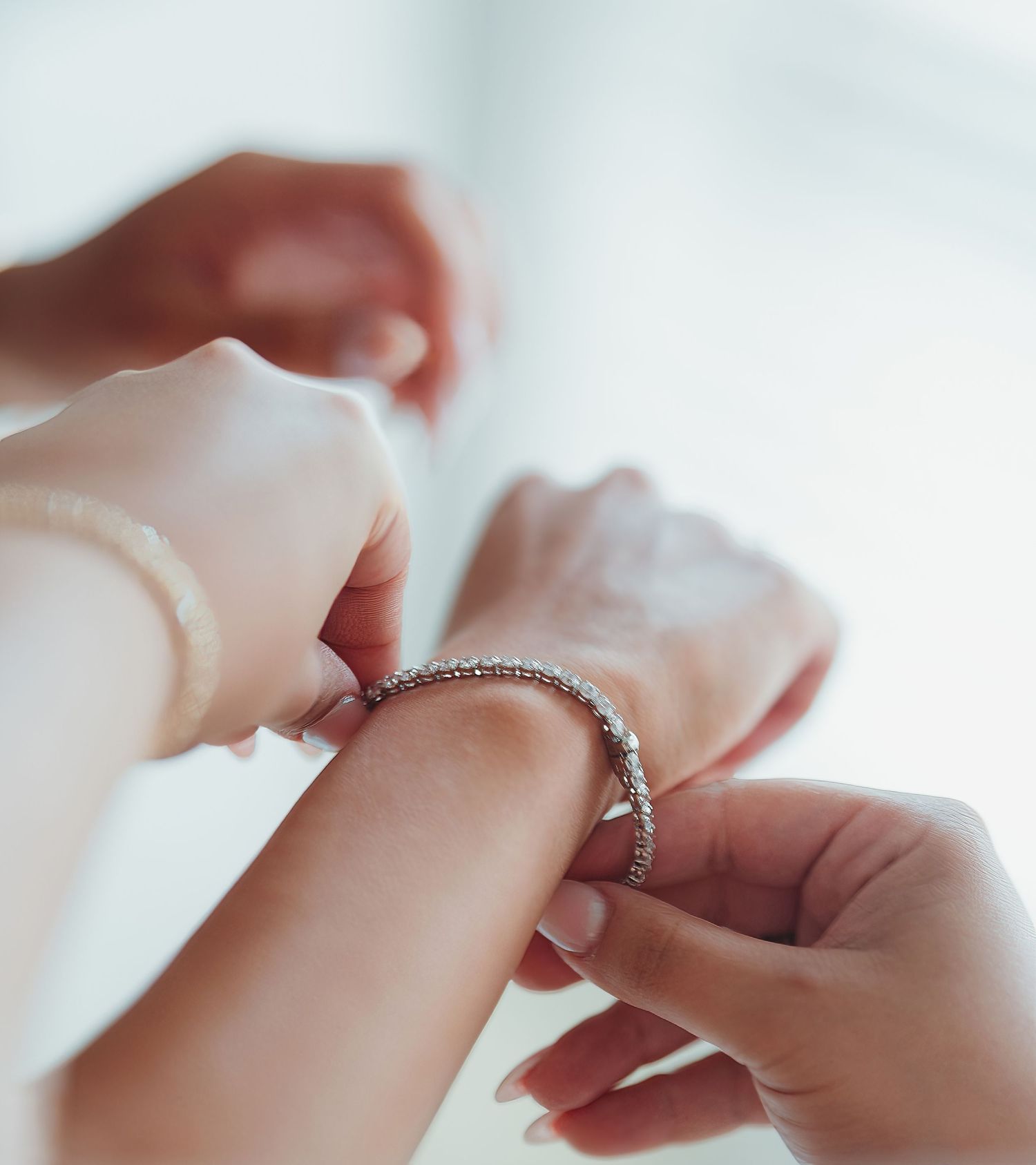 Close-up shot of hands exchanging engagement rings during a romantic proposal moment.