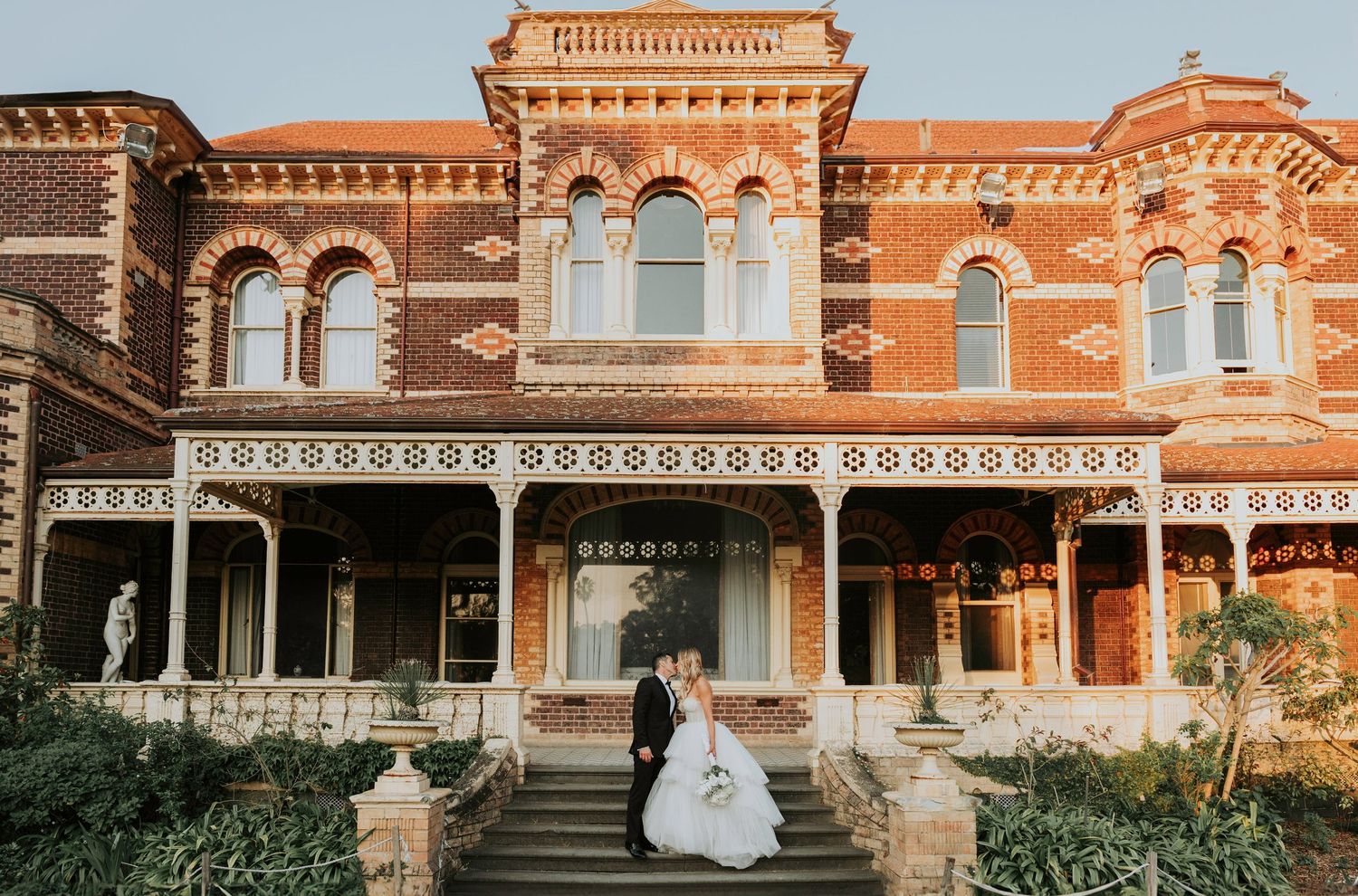 A series of photos showing a Victorian-style red brick mansion with ornate architectural details during a wedding celebration.