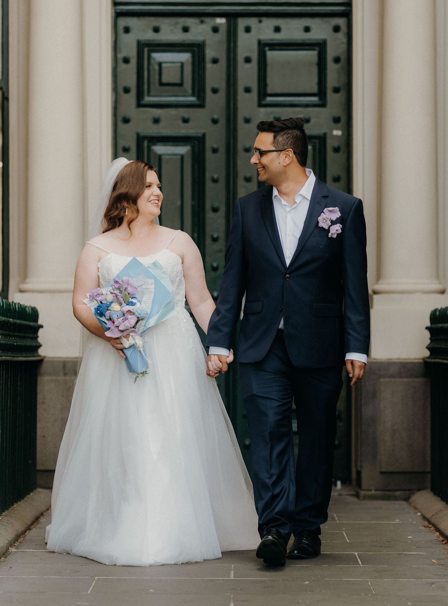 A romantic wedding photo series showing a couple in formal attire standing by elegant stone columns.