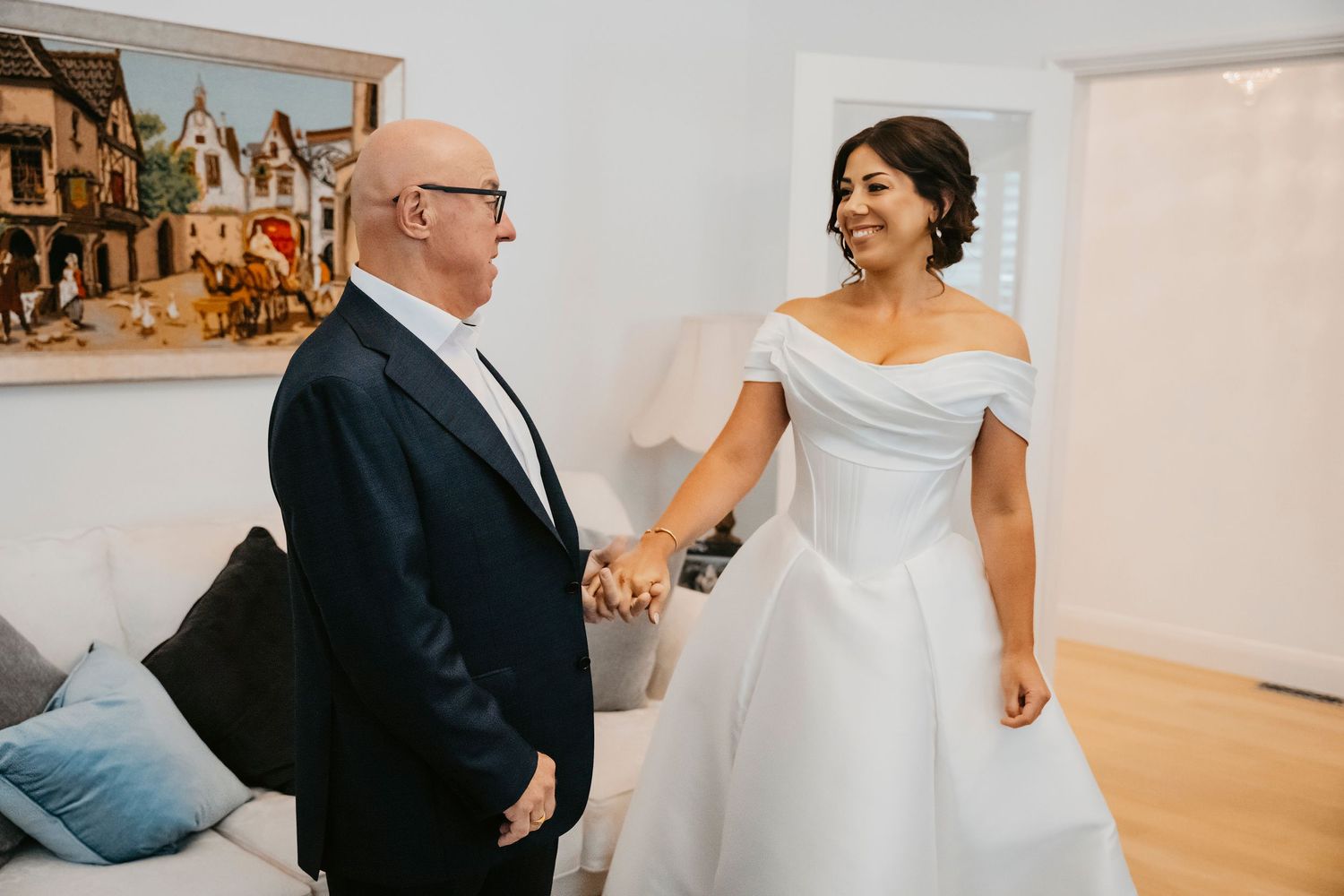 A series of candid wedding moments captured in a white and neutral-toned venue showing dancing and celebration.