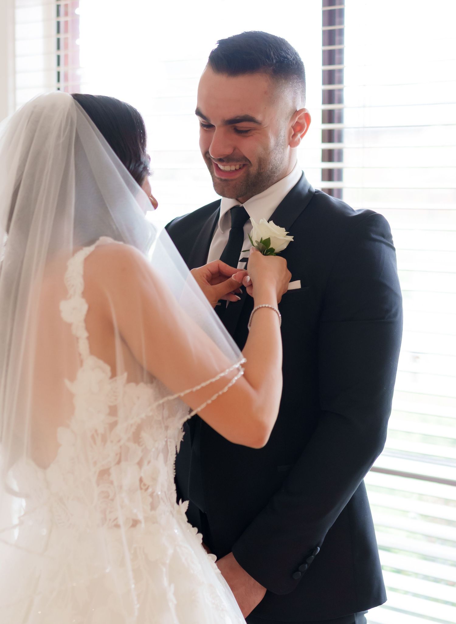 A series of three candid wedding photos showing a romantic first look moment between the bride and groom.