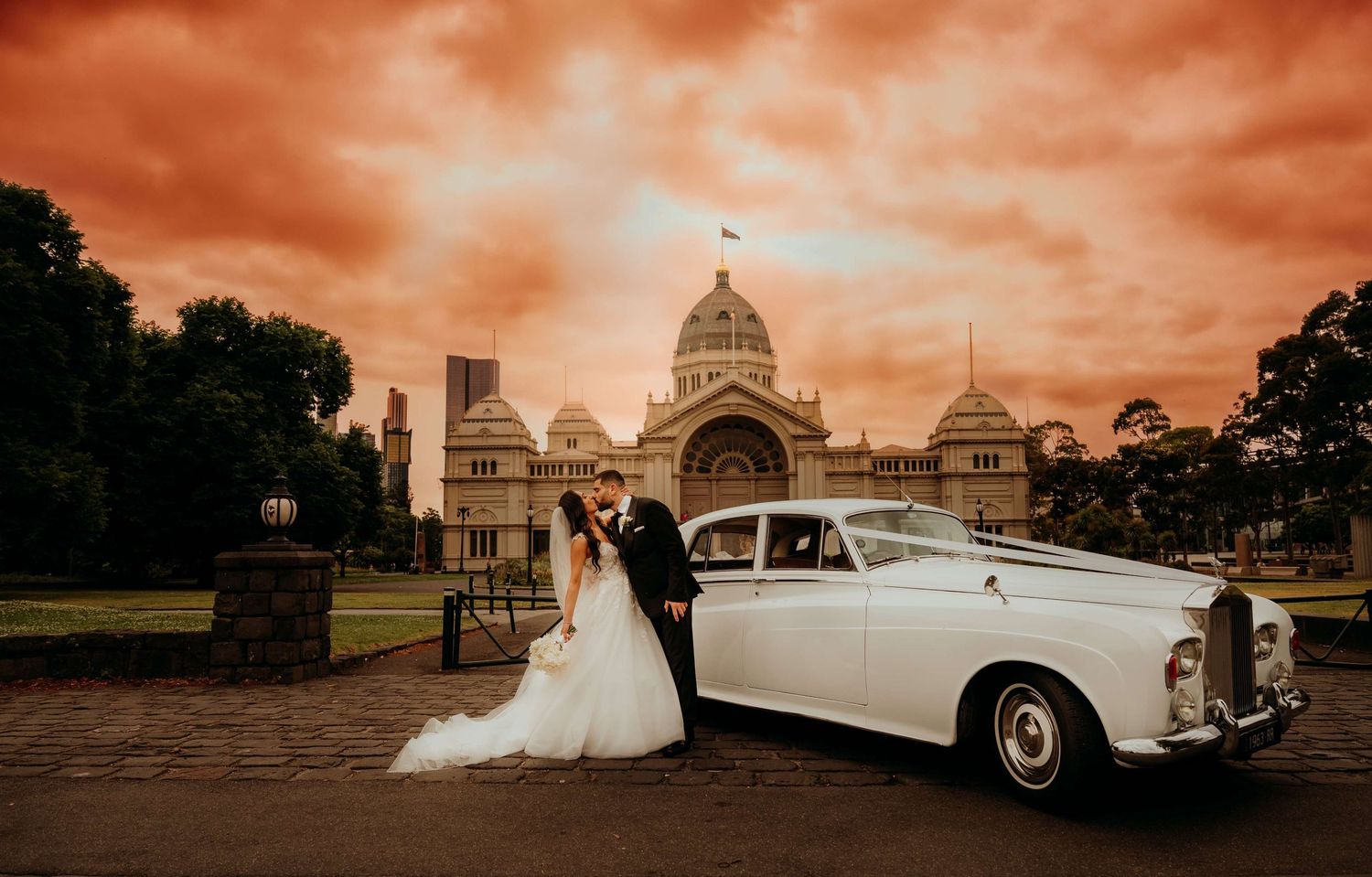 Seven vintage-inspired wedding photographs in sepia tones showing classic cars, architecture and romantic moments.