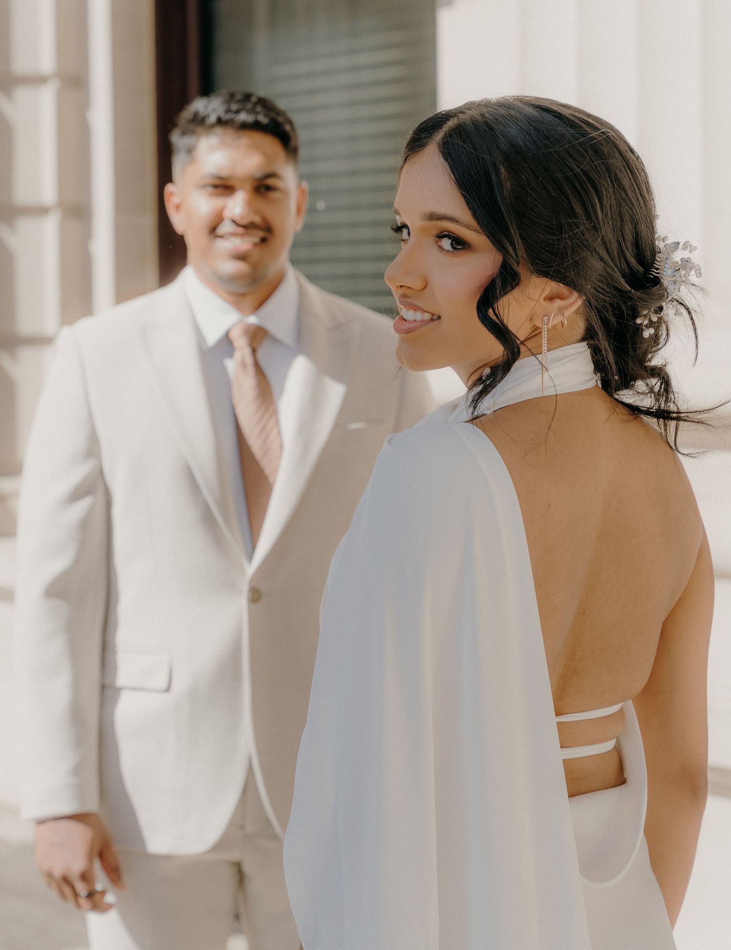 A wedding couple in white attire share romantic moments in a series of candid shots against a light background.