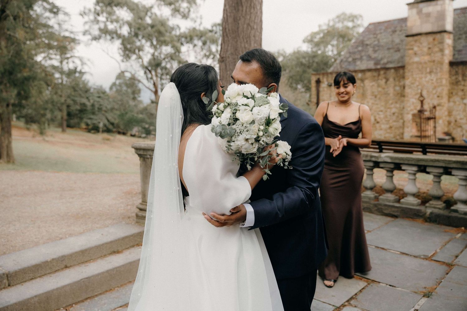 A romantic wedding ceremony captured in a series of intimate moments at an elegant outdoor stone venue.