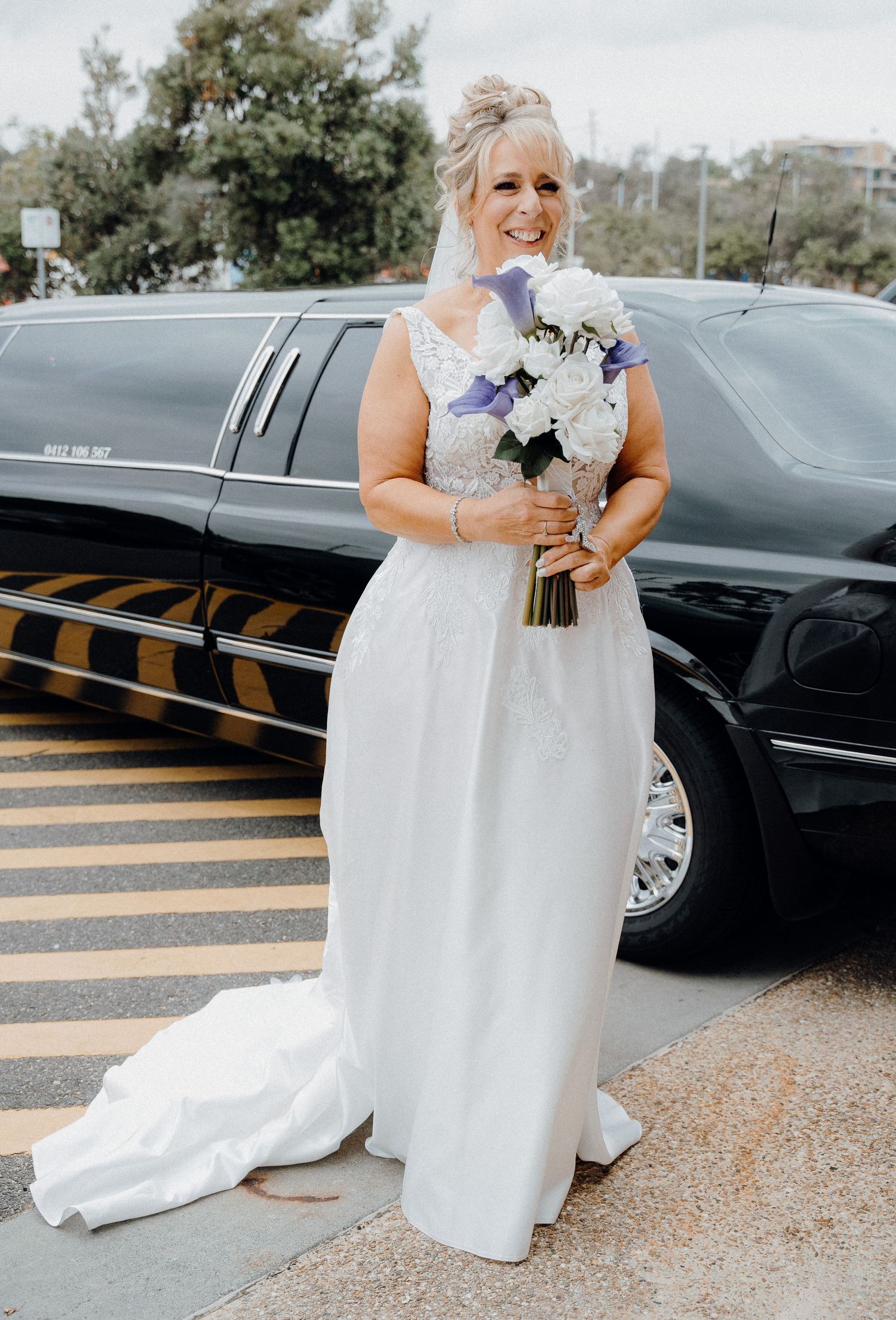 A series of photos showing the bottom half of a white wedding dress and bouquet against black cars in a parking lot.