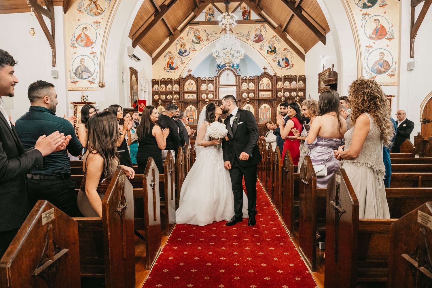 A series of wedding ceremony moments captured inside a traditional church with wood beams and elegant decor.