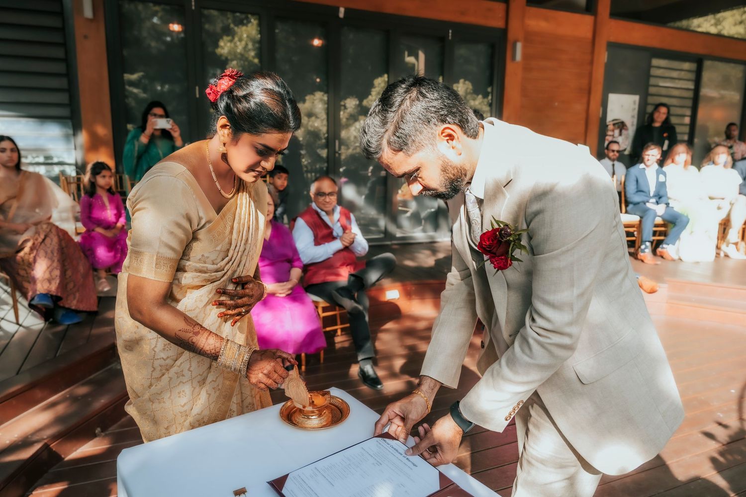 Wedding guests enjoying a fun balloon popping game during an outdoor reception celebration.
