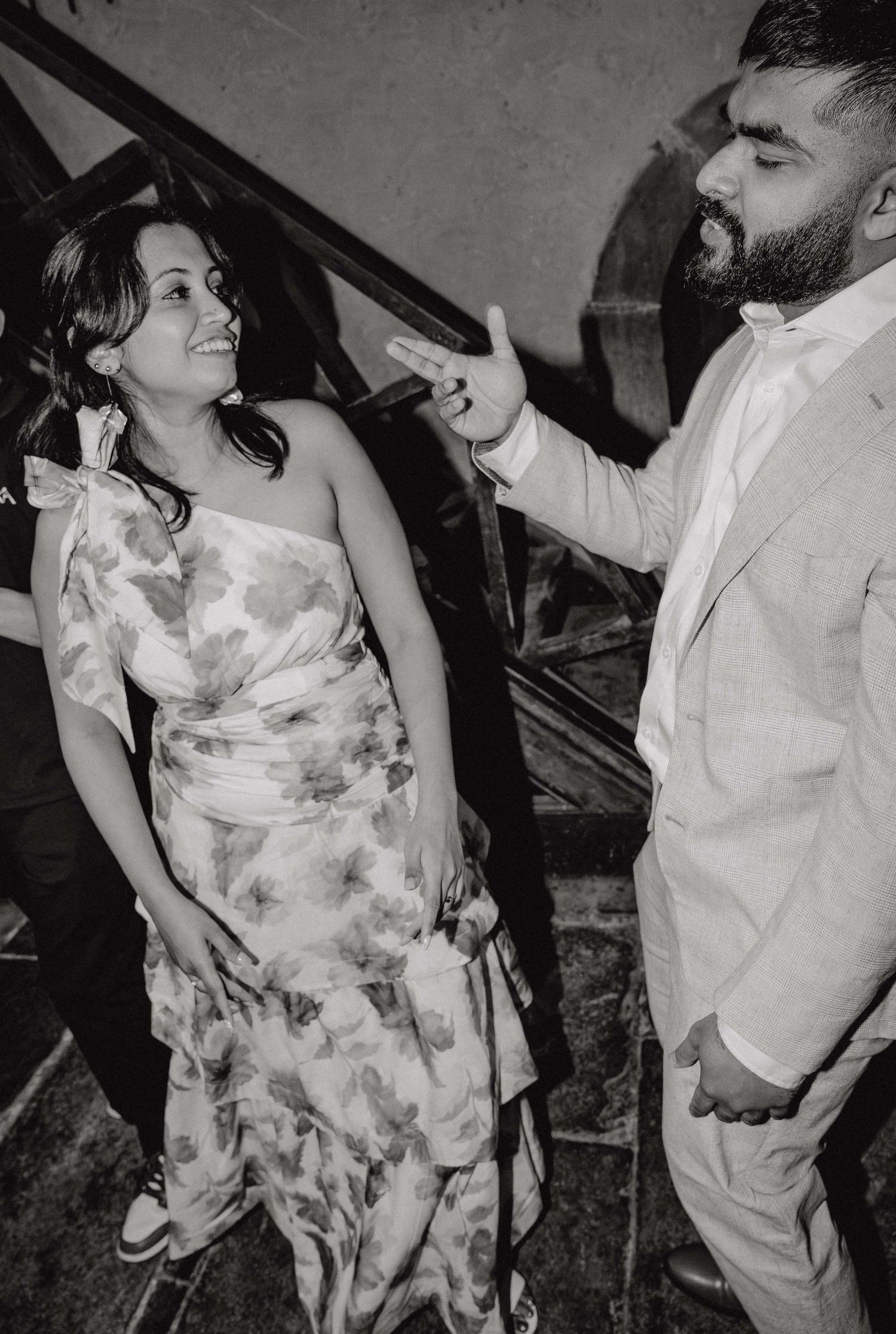 Black and white sequence of a couple dancing and embracing at what appears to be a social event or celebration.