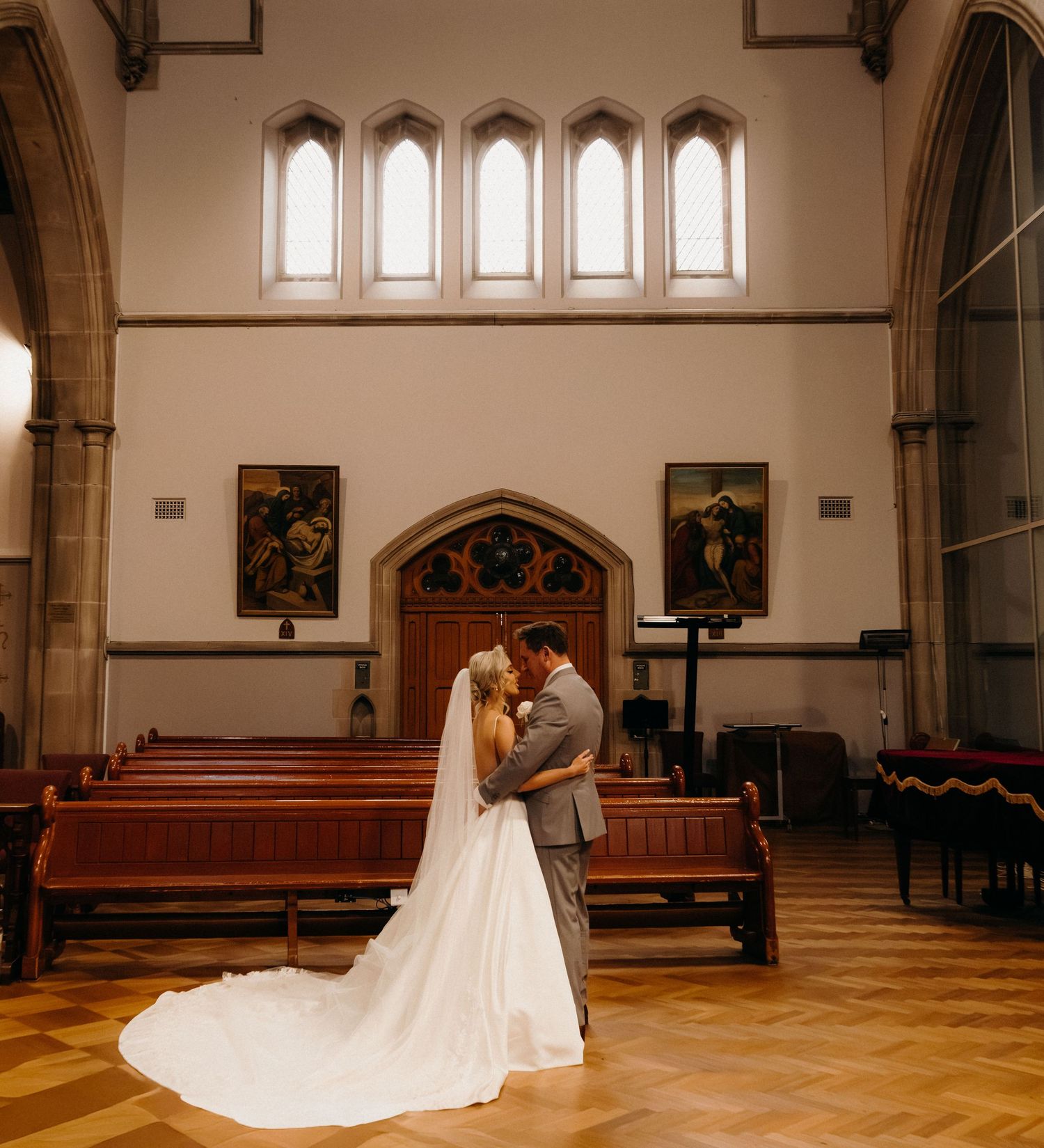 A panoramic sequence showing a couple in wedding attire dancing and embracing in a grand church interior.