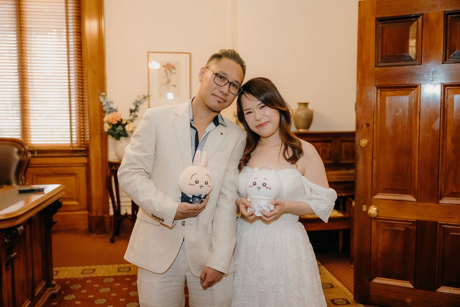 Wedding couple poses in multiple romantic shots at an elegant wood-paneled venue with warm lighting and classic decor.
