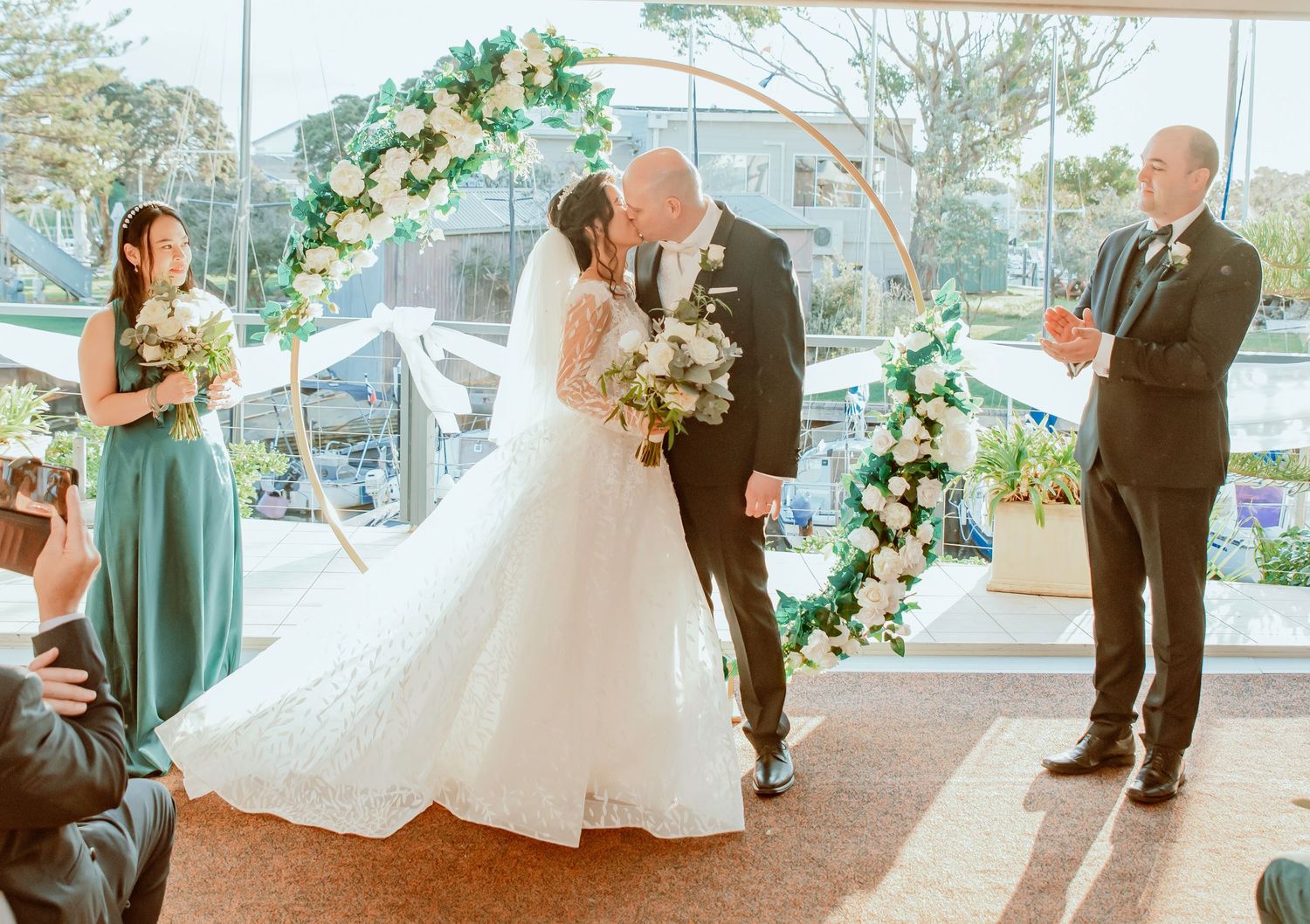 A wedding ceremony sequence showing a couple exchanging vows in an elegant venue with floral decorations and natural lighting.