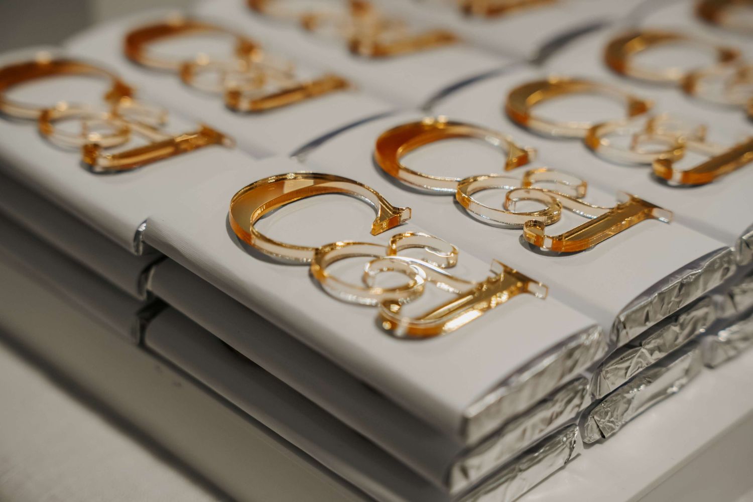 Close-up view of gold wedding rings lined up neatly in rows on a jewelry display case.