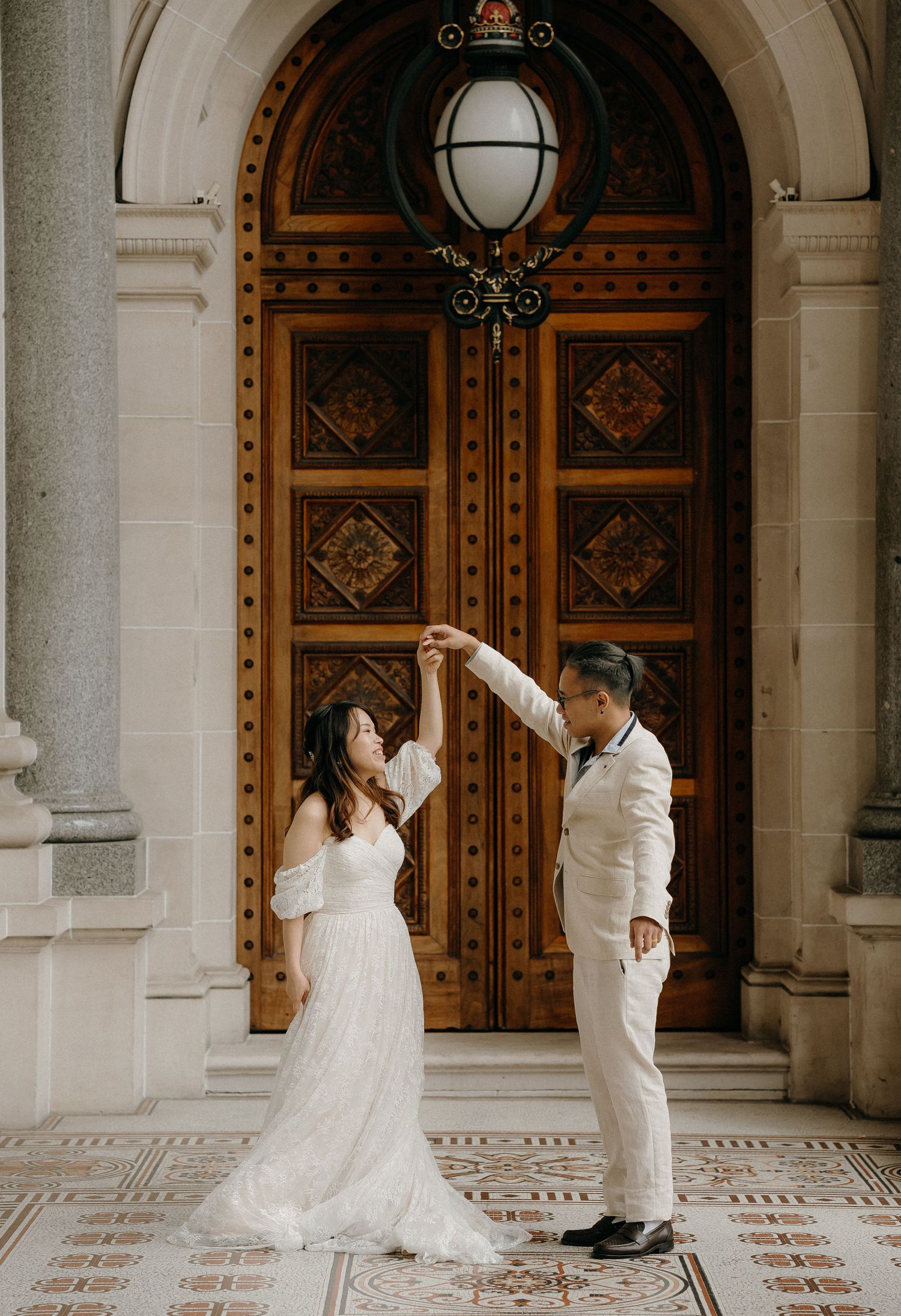 A sequence of wedding photos showing a couple dancing and twirling together in front of ornate wooden doors.