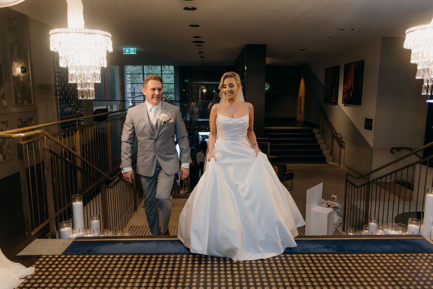 A collage of wedding photos showing a bride and groom walking down stairs and posing in an elegant indoor venue.
