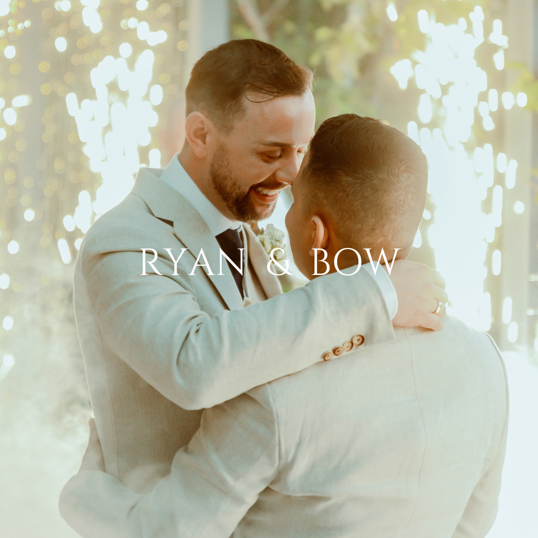 Two people sharing a joyful embrace in light-filled wedding ceremony setting.