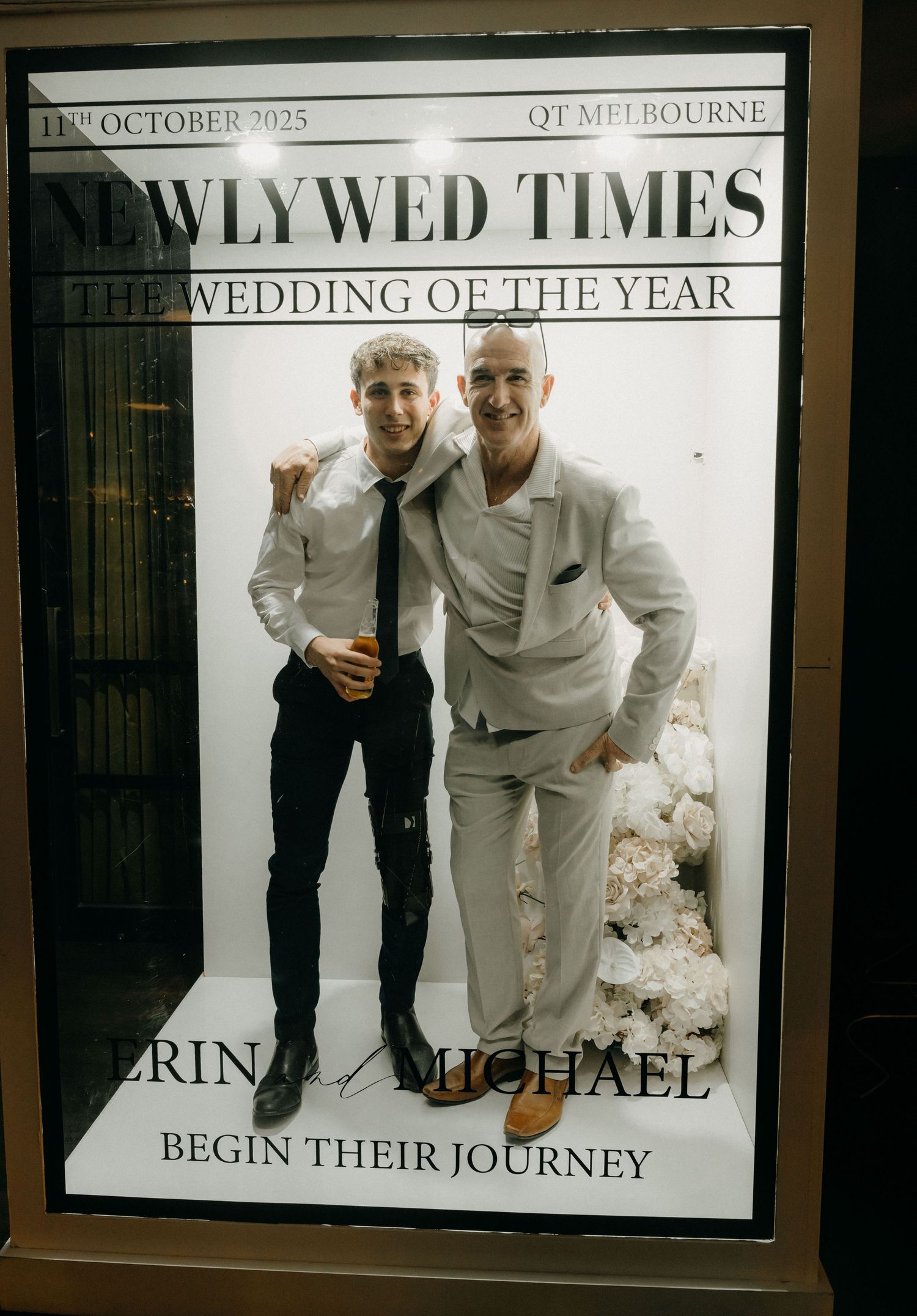 Black and white wedding announcement display showing text and decorative frames with 'Newlywed Times' headline.