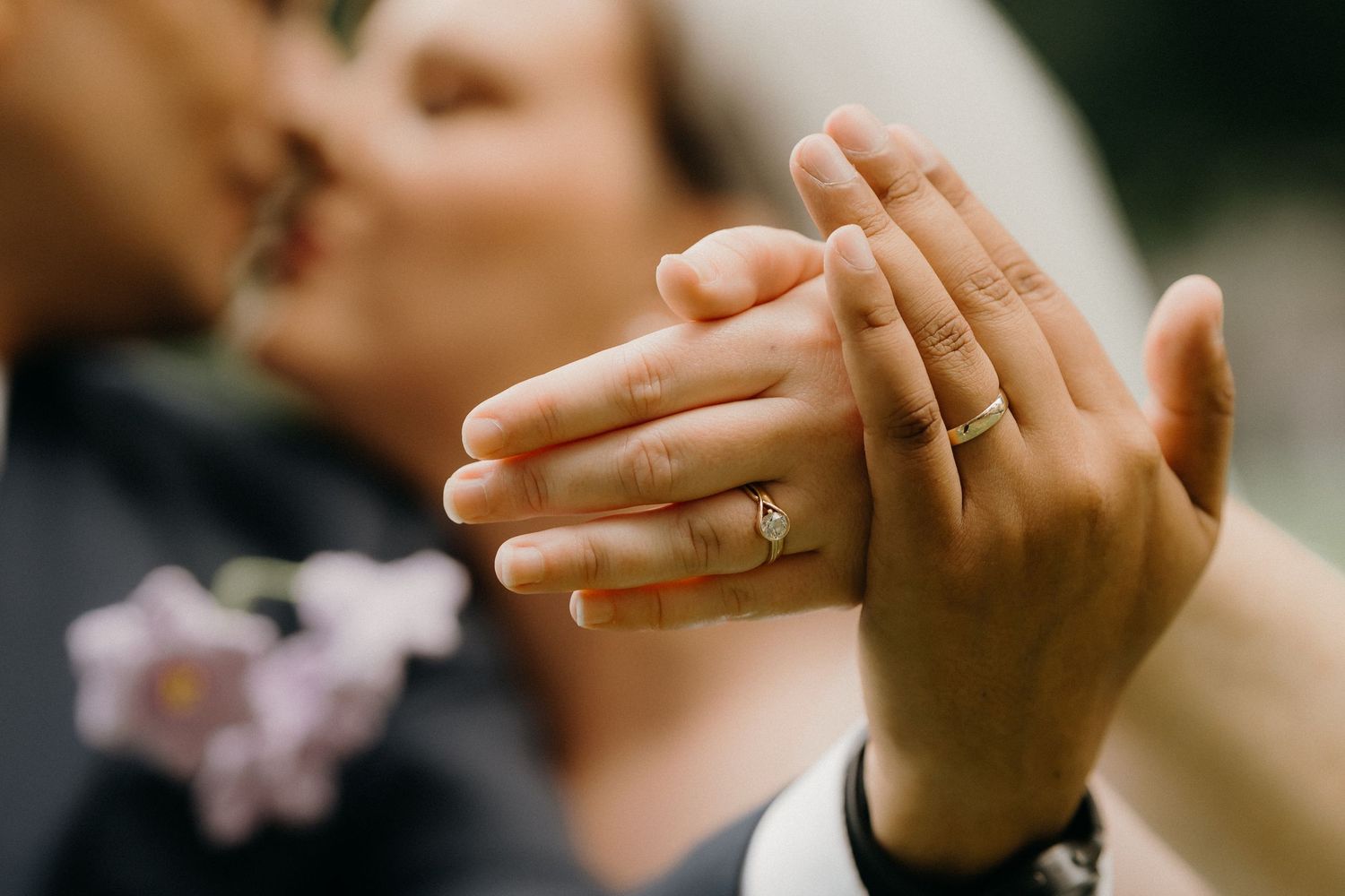 Close-up shot of hands exchanging wedding rings during a romantic ceremony.