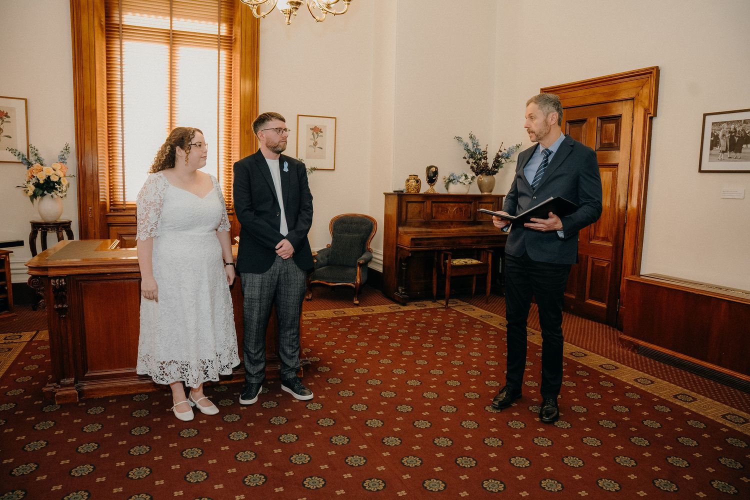 A collage of wedding ceremony moments showing people in formal attire inside an elegant room with wood paneling and red carpet.