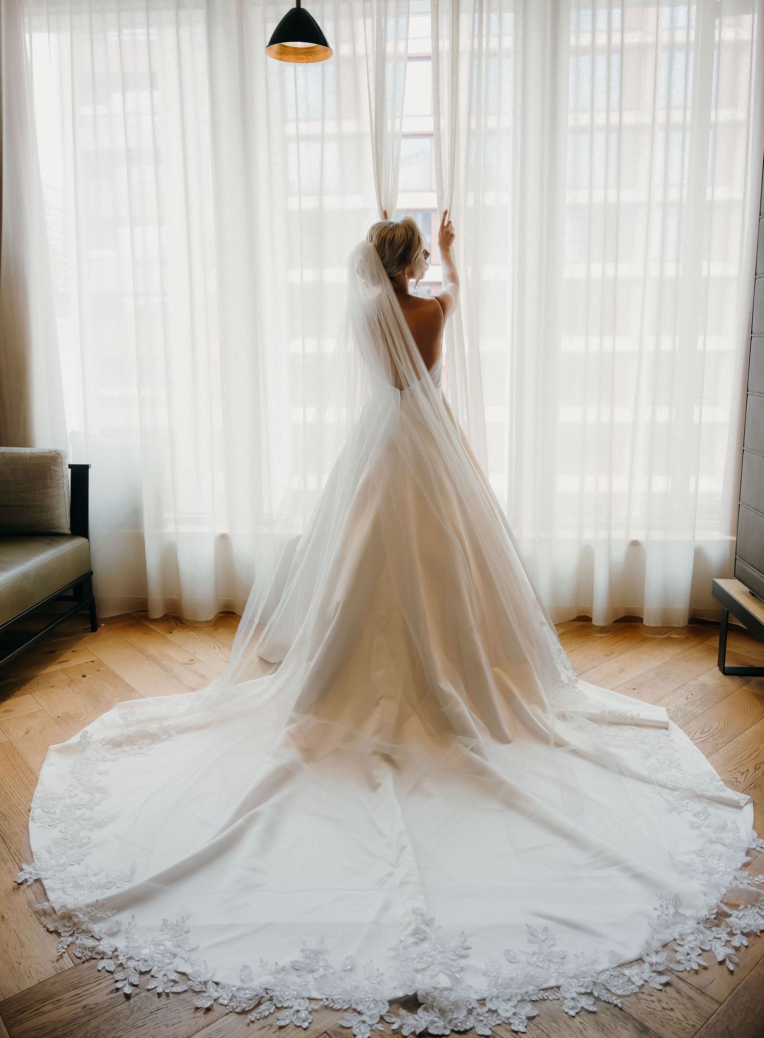 A stunning white wedding dress with a long cathedral train and delicate lace details shown from multiple angles.
