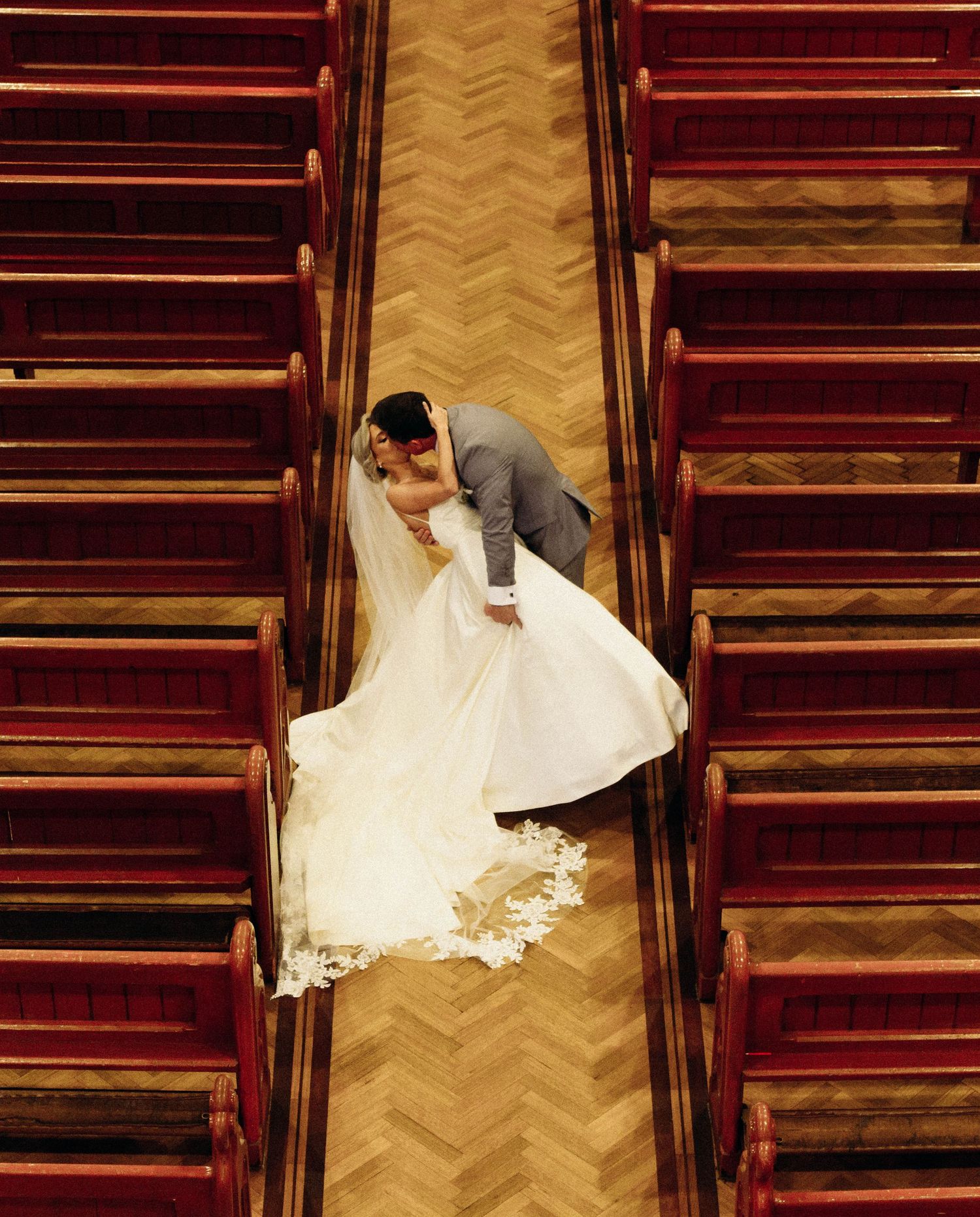 A creative sequence showing a person in a white dress descending red-carpeted stairs in a zigzag pattern.