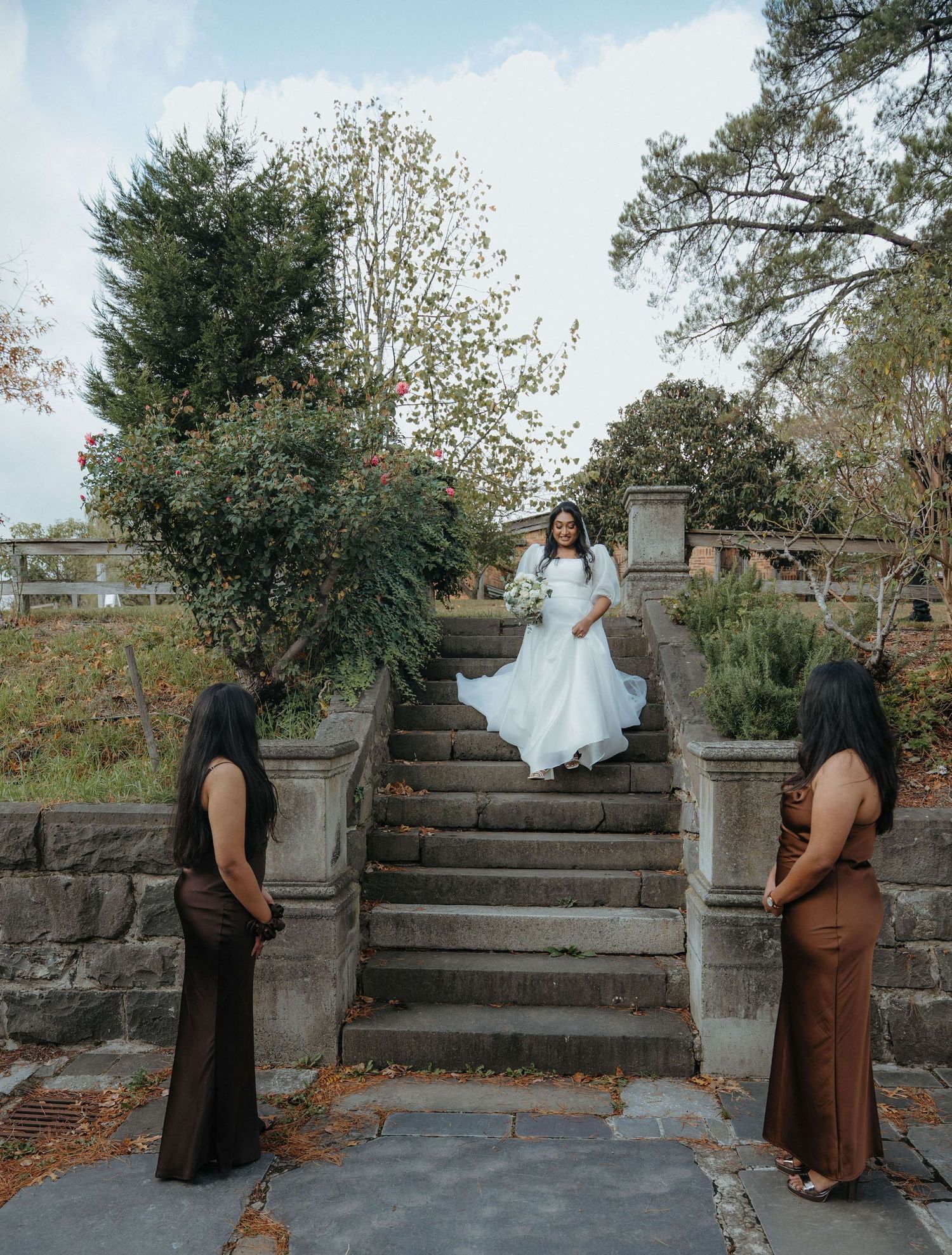 A sequence of five photos showing figures sitting on stone steps outdoors in autumn with trees in the background.