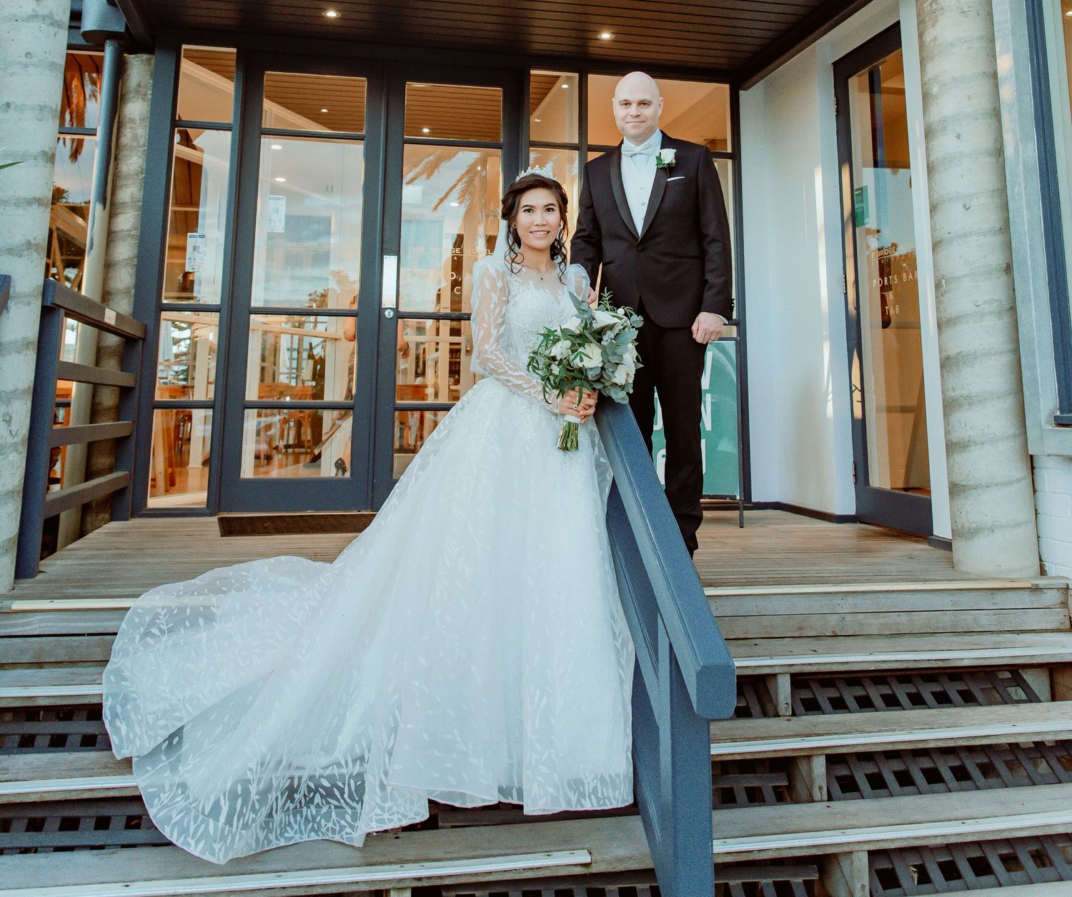 A collage of five outdoor wedding photographs featuring a couple on the porch of a classic stone building.