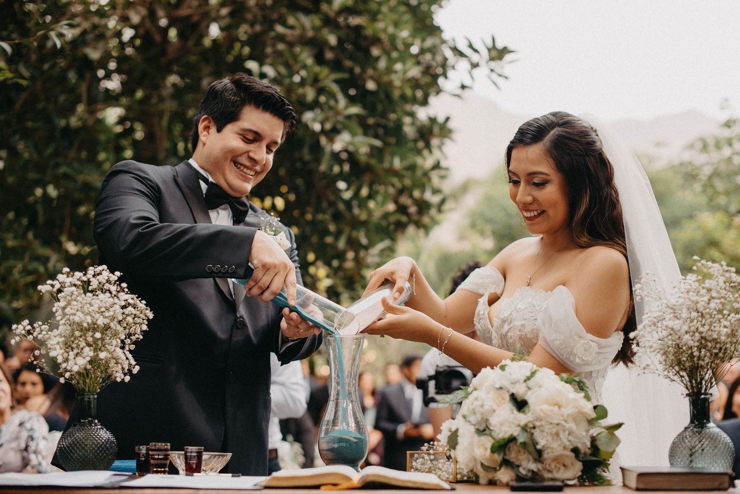 Couple shares romantic moments during their outdoor garden wedding celebration.