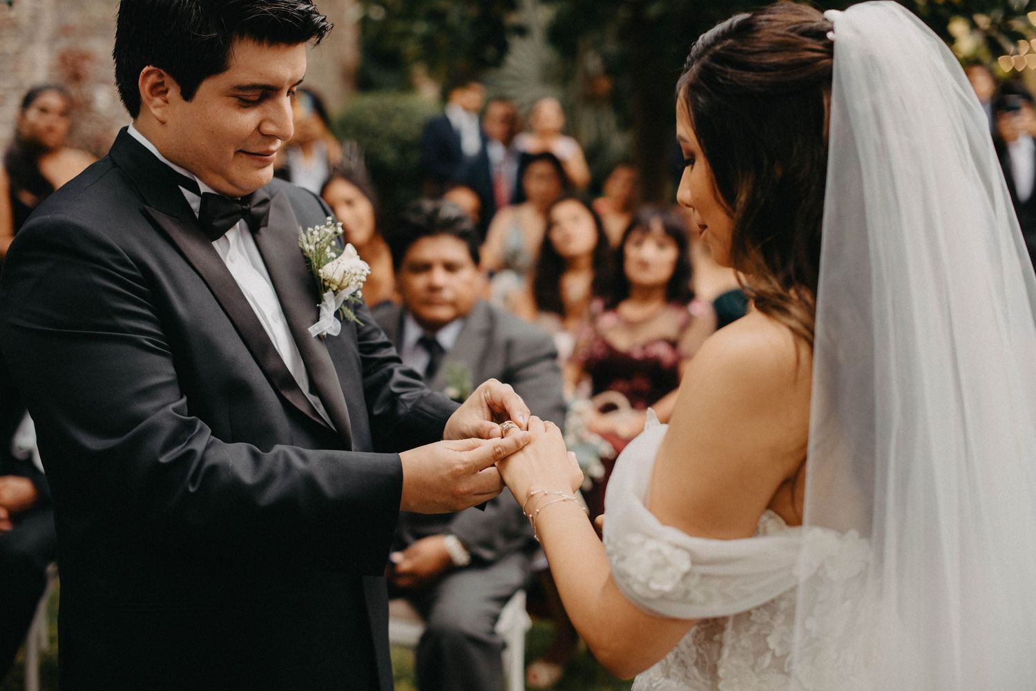 First dance at an outdoor wedding reception with string lights and floral decorations.