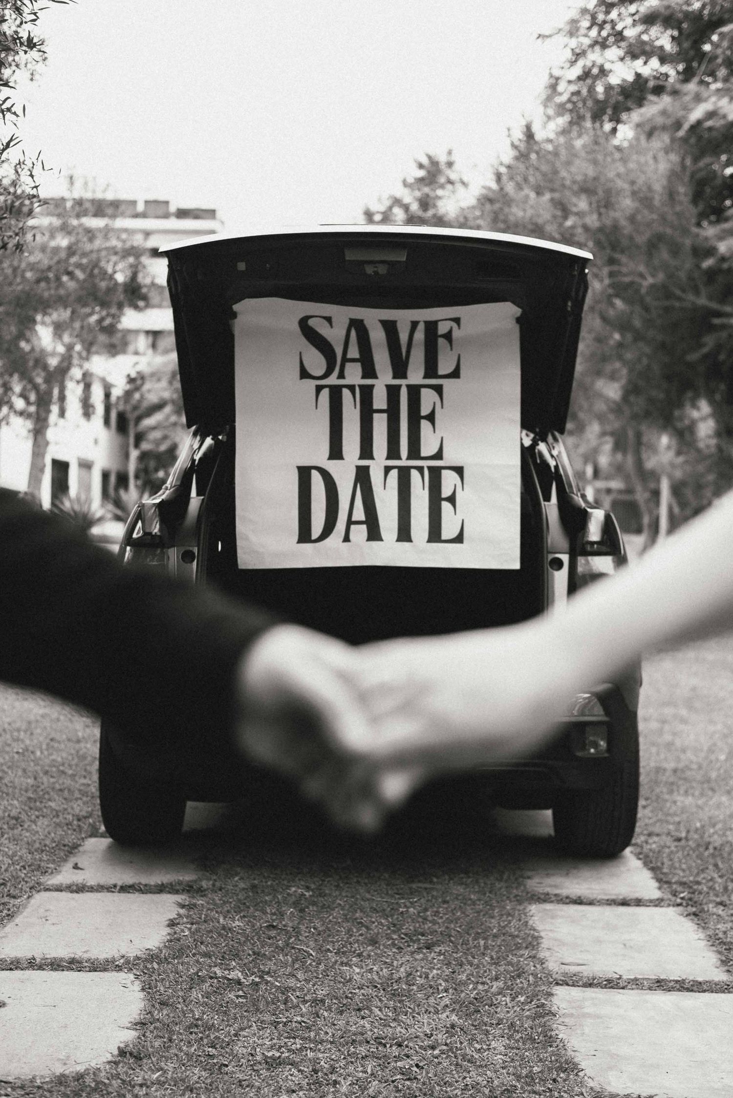 Creative save the date photo series with text displayed on dark boards.