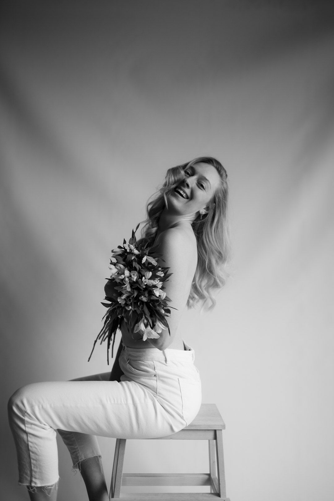Artistic black and white photo series showing a figure in white dress posing gracefully against neutral background.