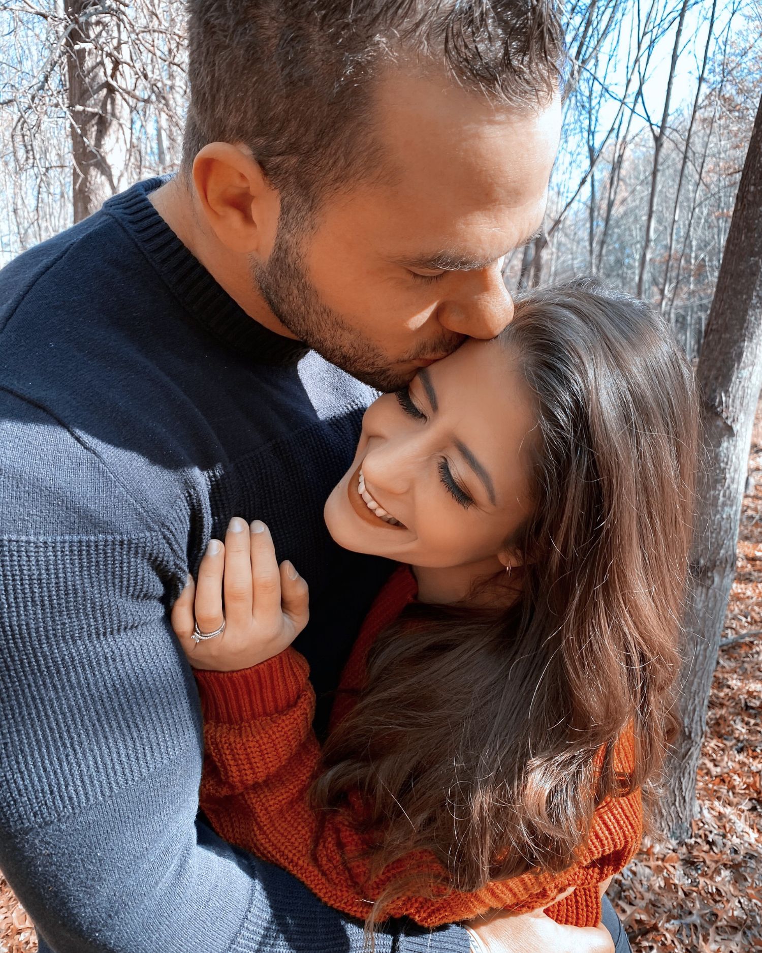 Hudson Valley photographer Cassie Vee laughing with her husband, during a candid autumn engagement session outdoors