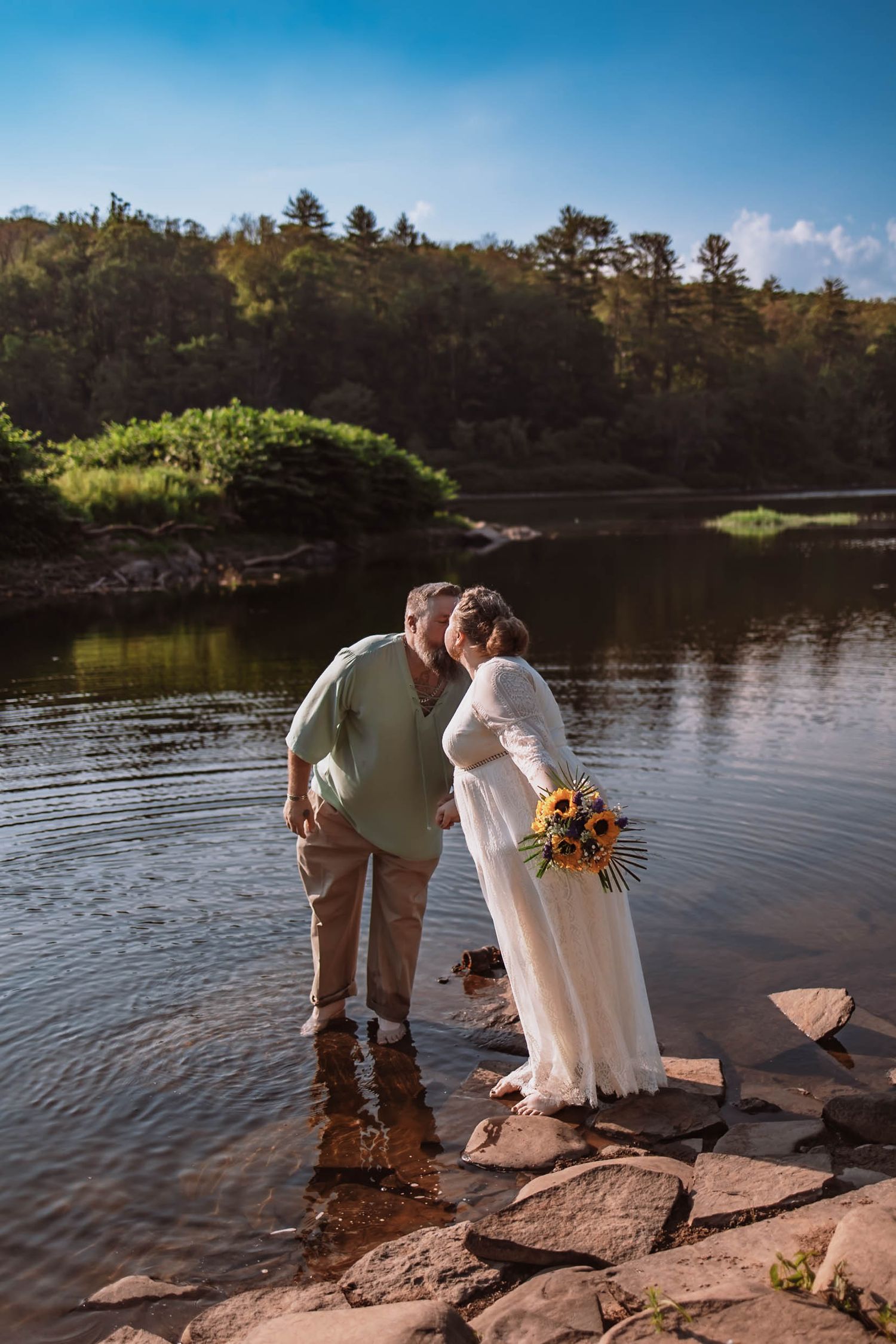 Intimate Hudson Valley elopement photographer captures bride and groom sharing an intimate moment by the river during an elopement