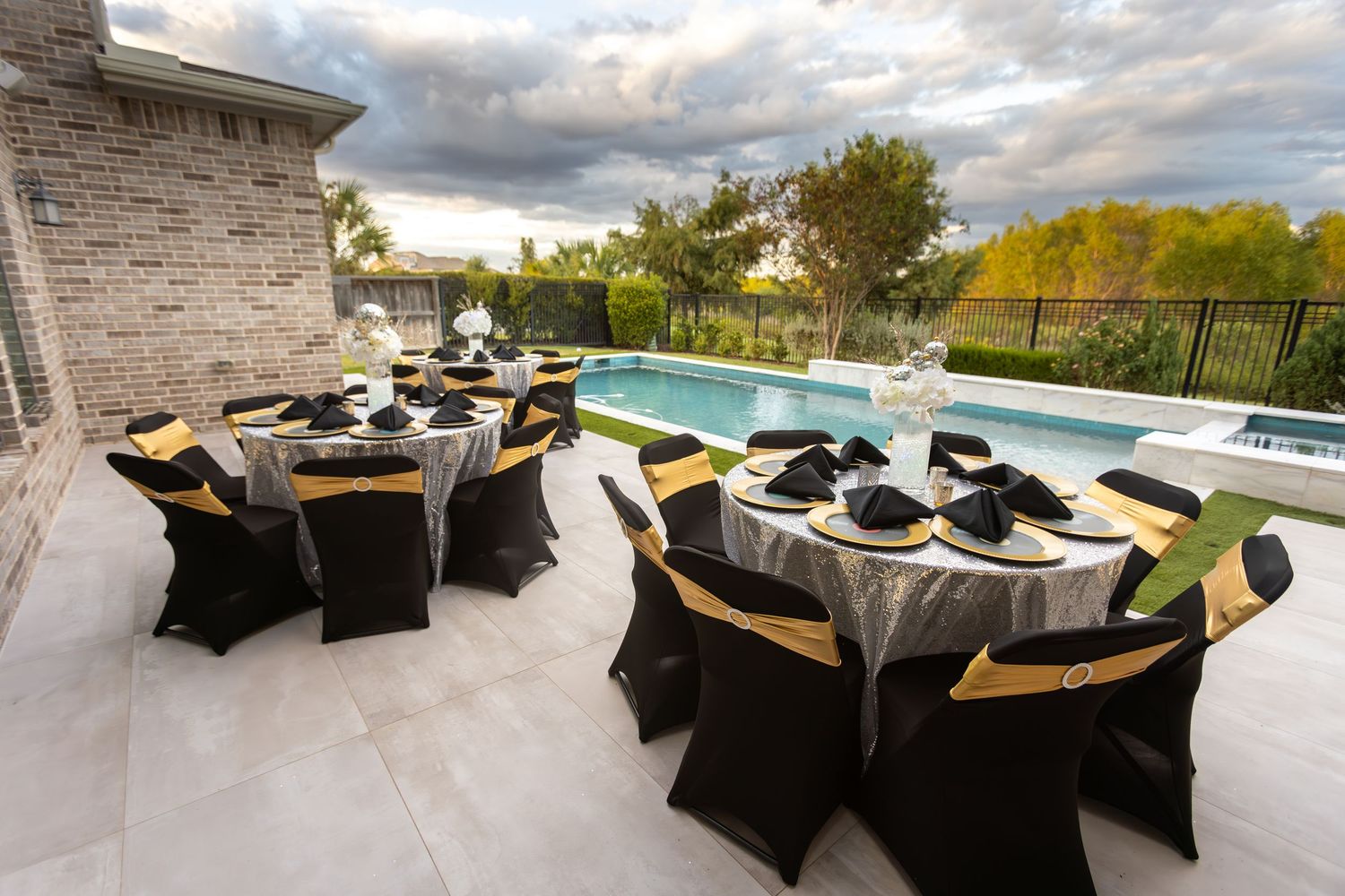 Elegant outdoor dining setup with black chairs and white tablecloths overlooking a scenic landscape view.  Missouri City Family Photographer