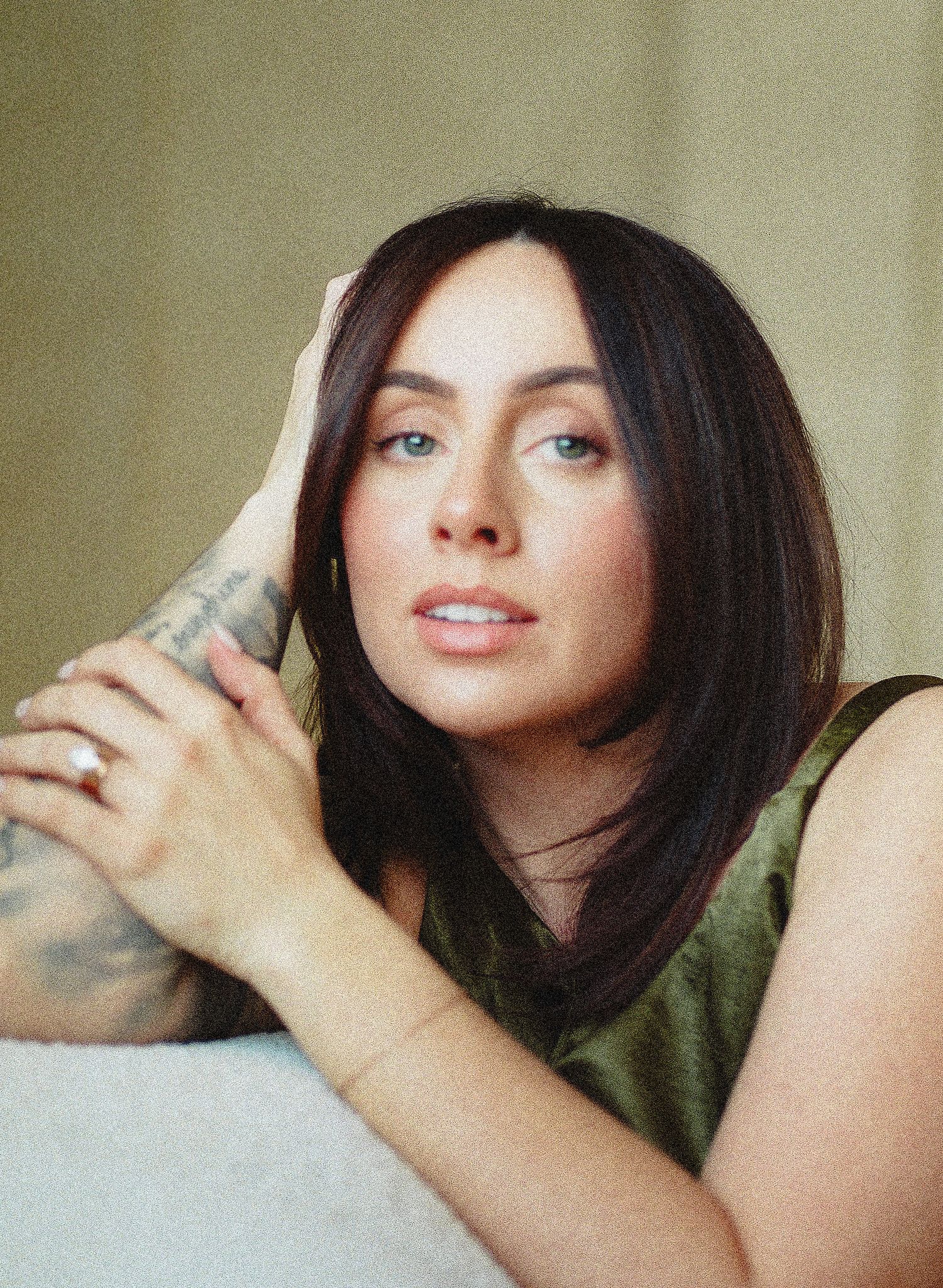 Artistic portrait series showing a person with dark hair in soft lighting against a neutral background.