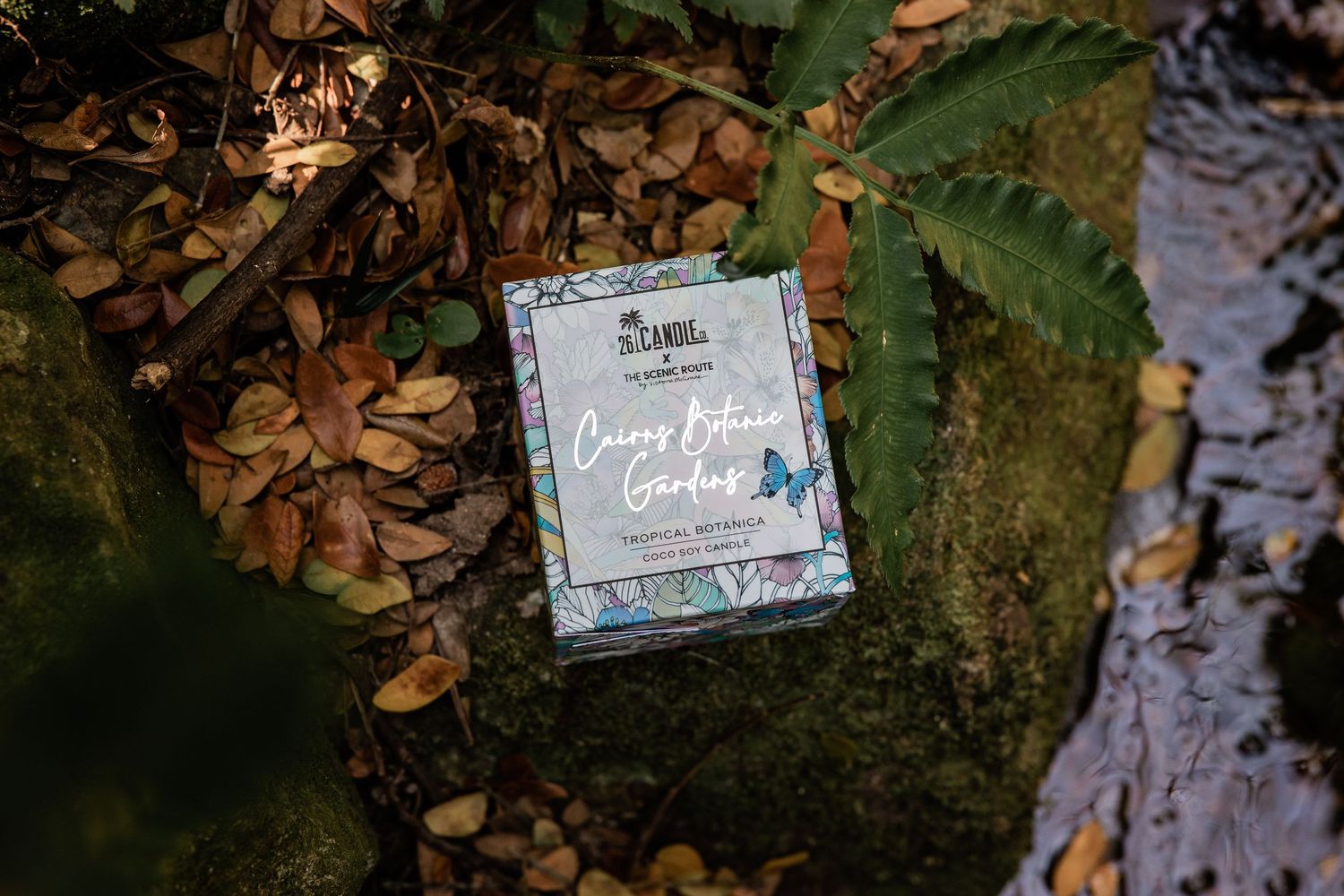 A floral-themed book titled 'Living Forever Changes' resting on a mossy forest ground with autumn leaves.