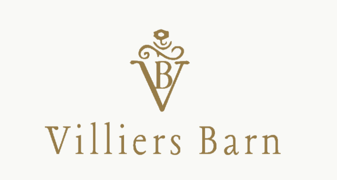 Villiers Barn elegant gold logo featuring a decorative monogram with intertwined V and B letters topped with a rose emblem.