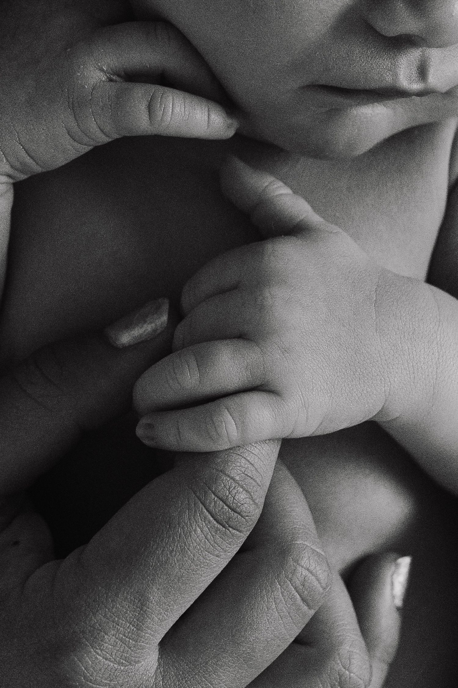 A black and white series of close-up photographs showing hands covering a mouth in different positions.