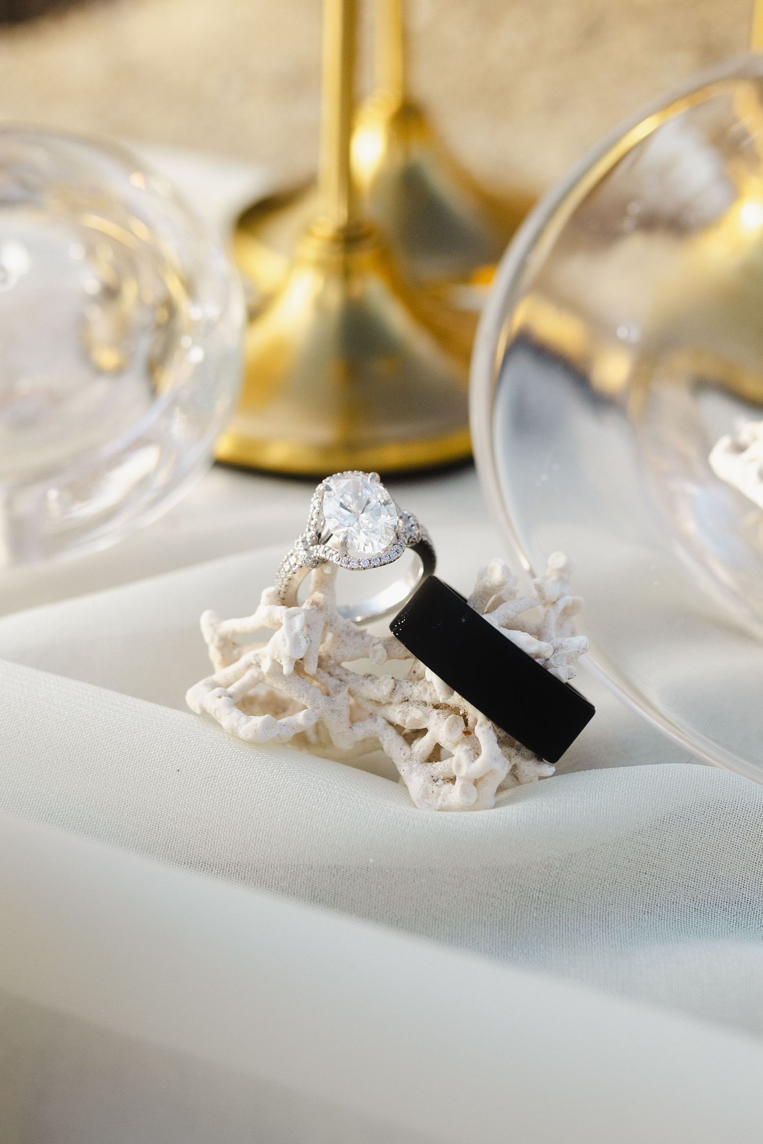 A series of five macro shots showing crumpled paper napkins and black cloth on a white tablecloth with golden details.