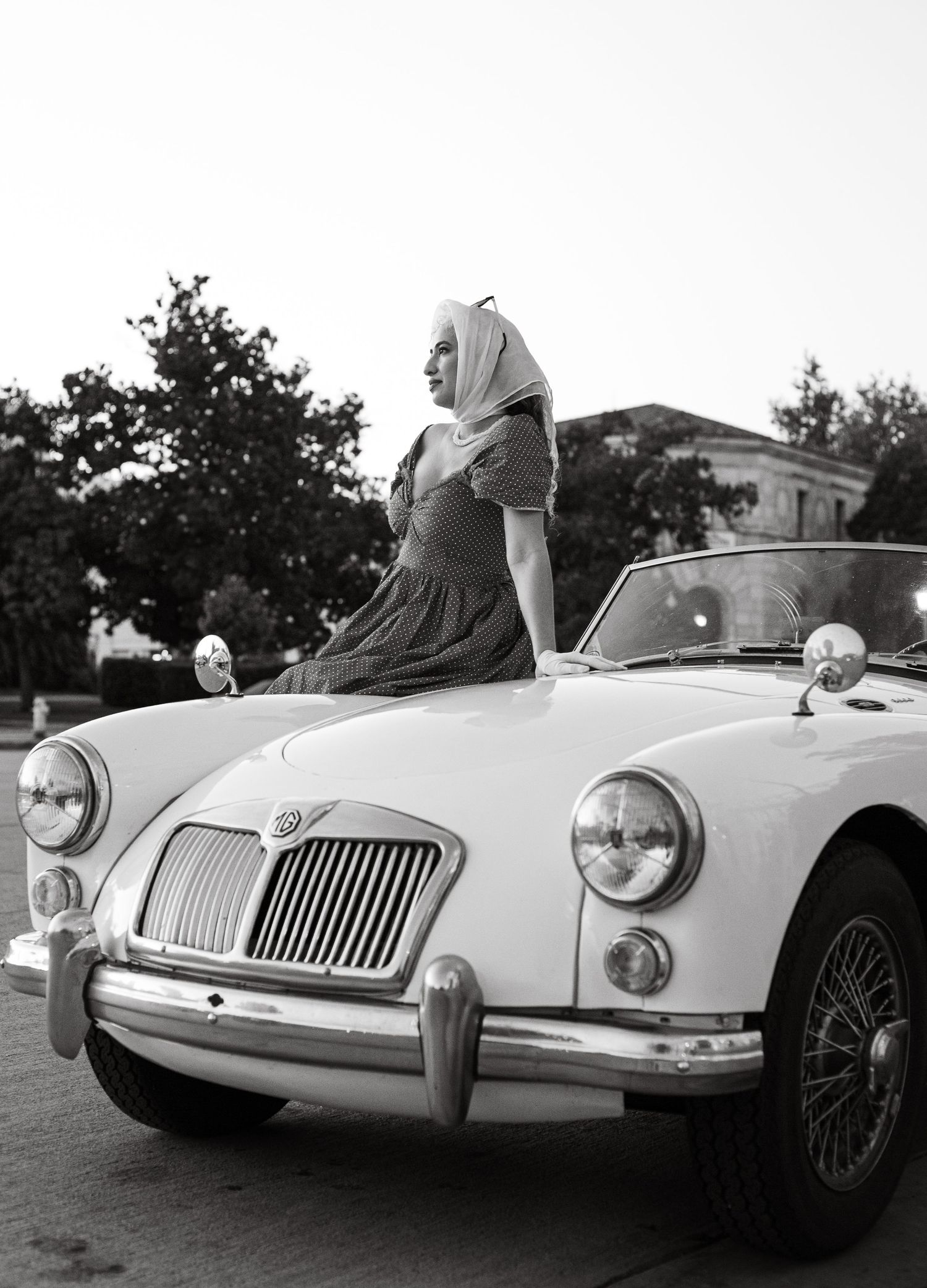 Classic white MG sports car shown in sequential profile shots against trees.