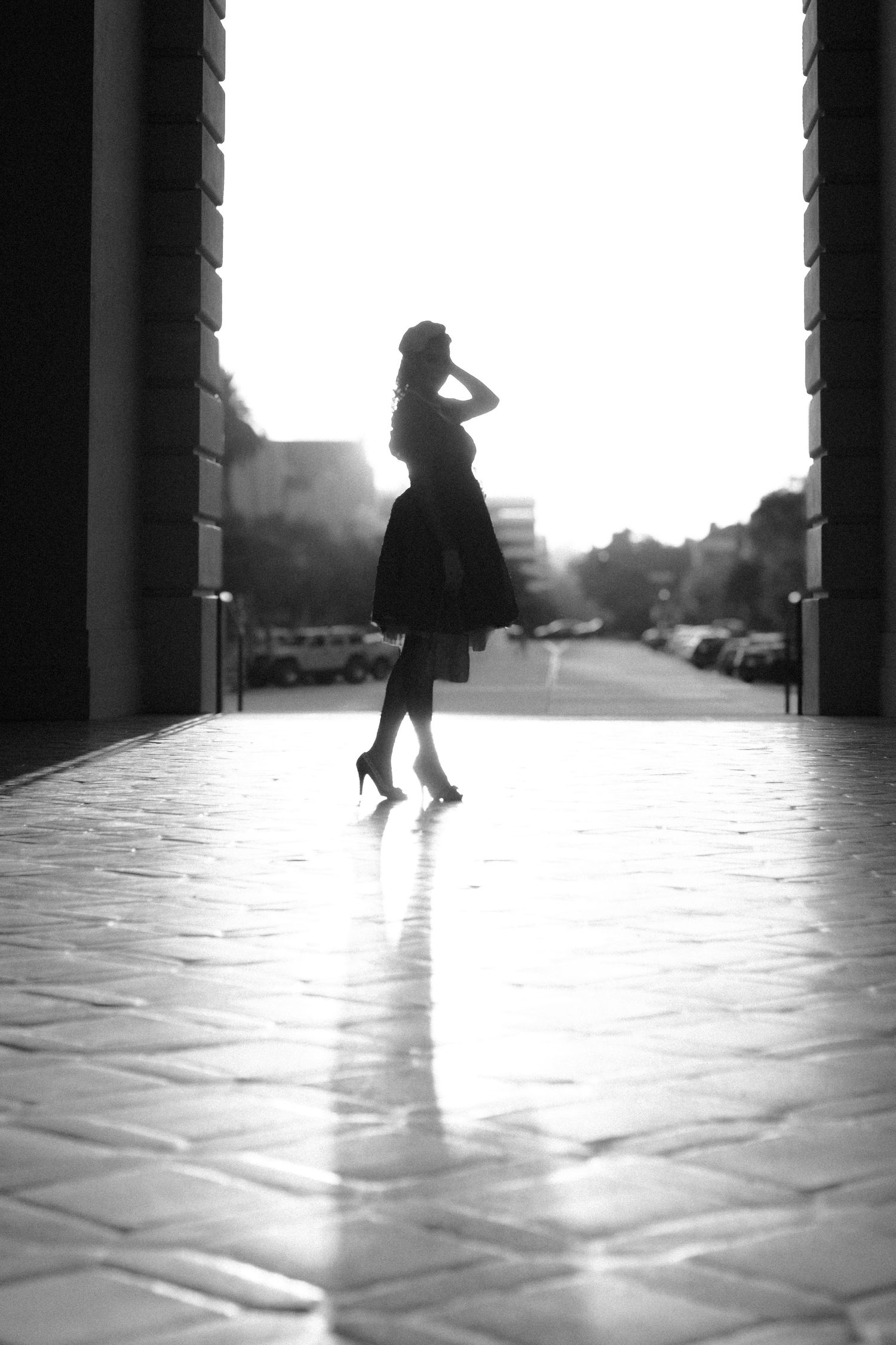 Black and white sequence capturing moving figures across a sunlit floor.