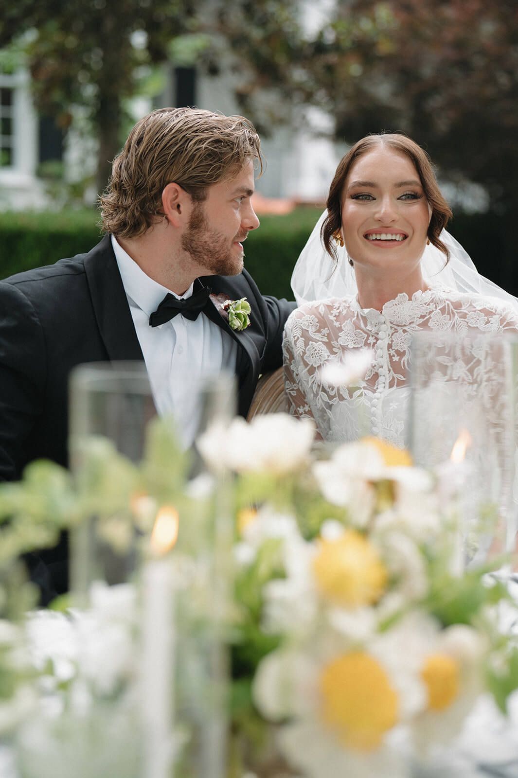 A bride and groom sitting at reception table at Tomball Tx wedding venue