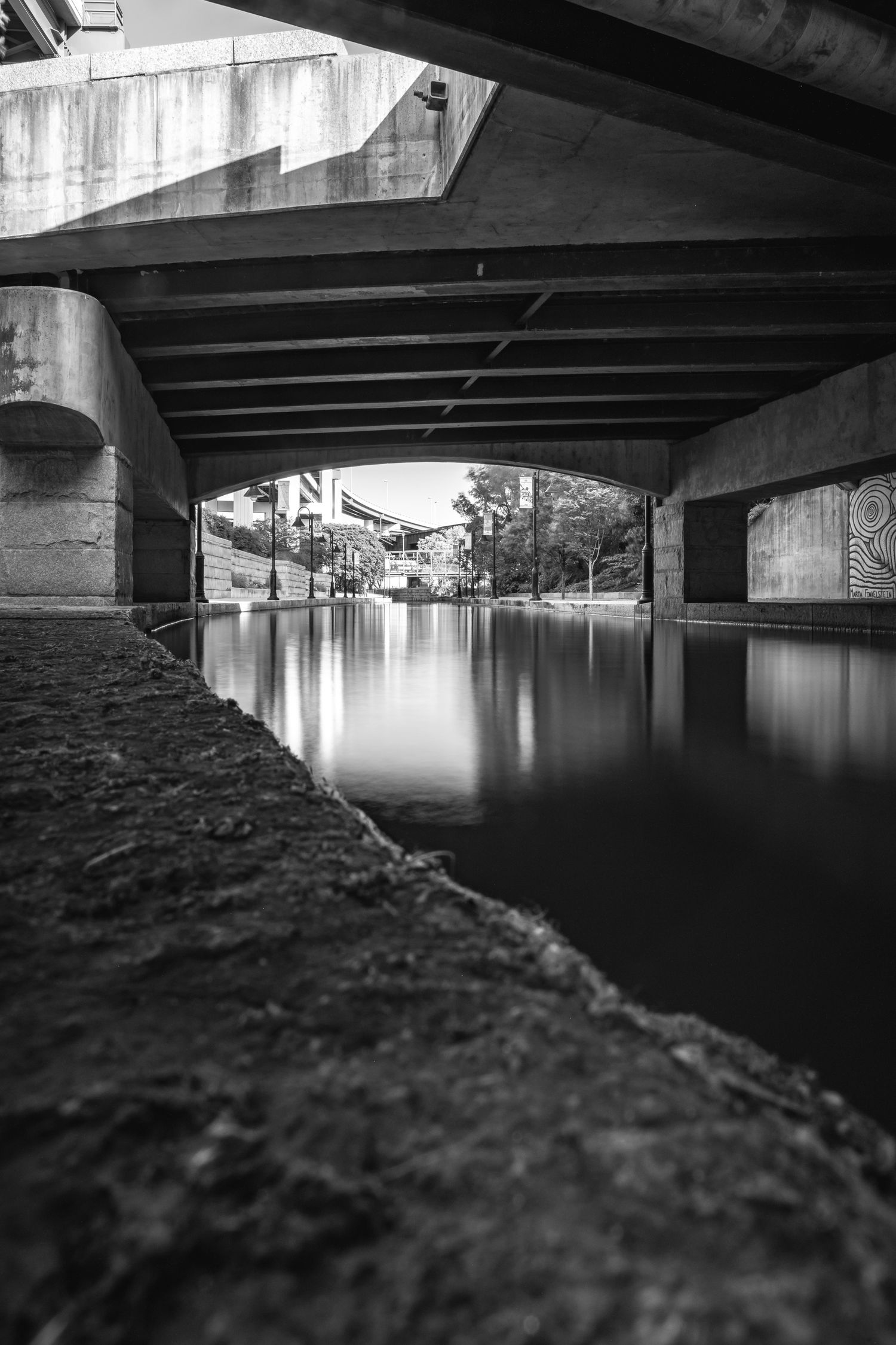 A black and white photo of a canal in Virginia with unique architecture