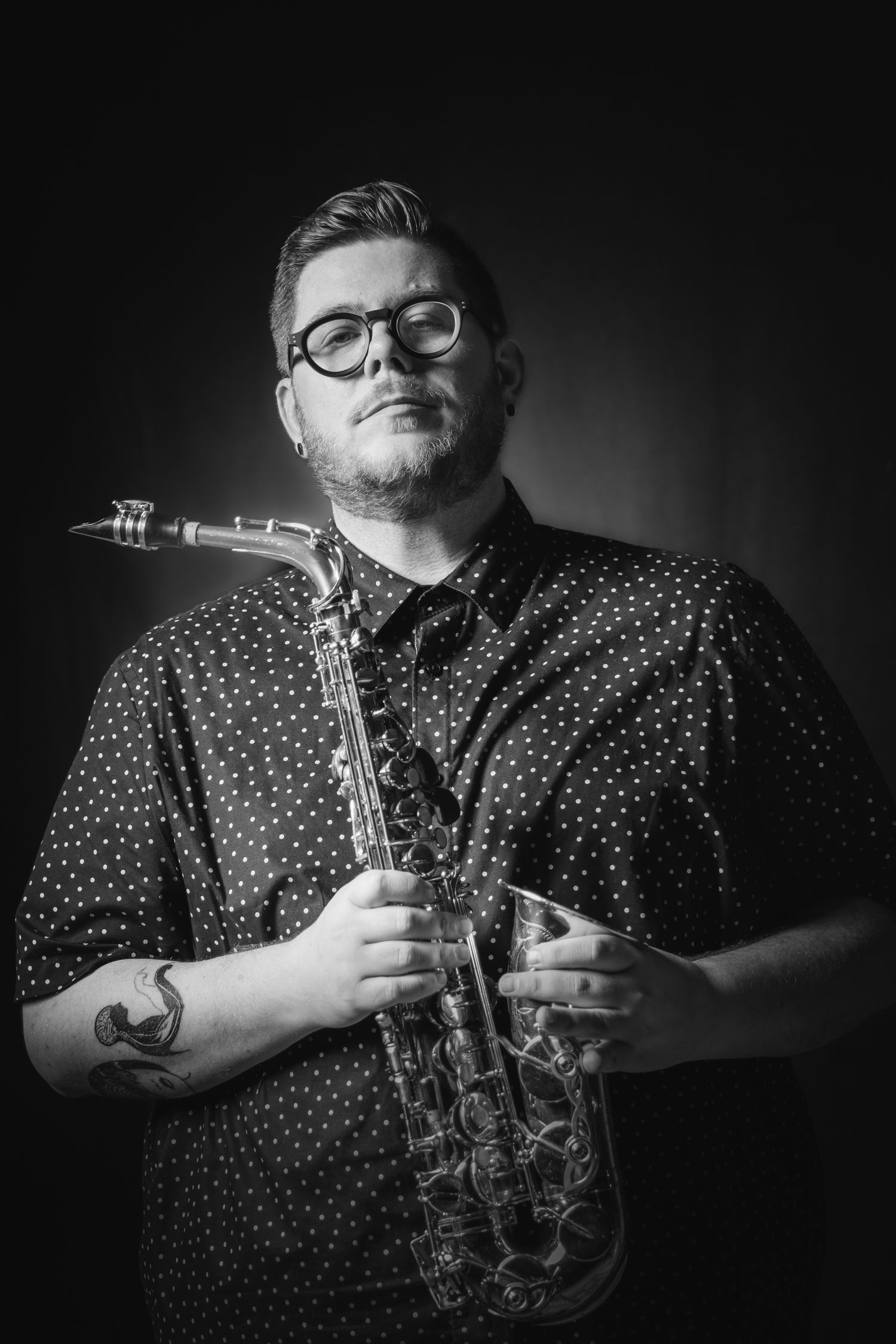 An incredible portrait of a musician with his saxophone surrounded by dramatic lighting