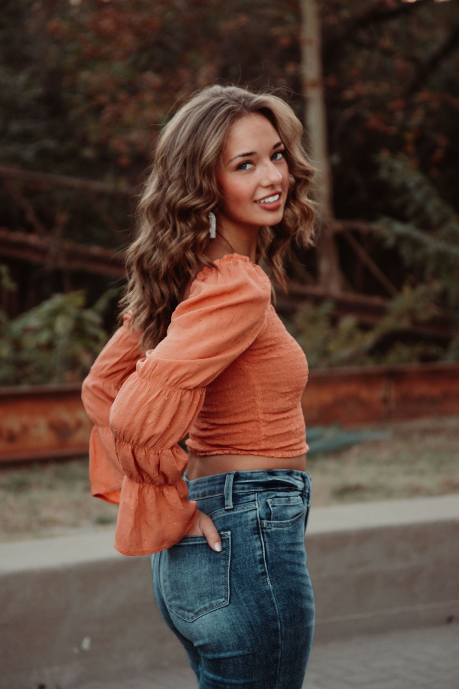Senior portrait in natural outdoor setting during golden hour. Kentucky lifestyle photographer captures relaxed, authentic moments.