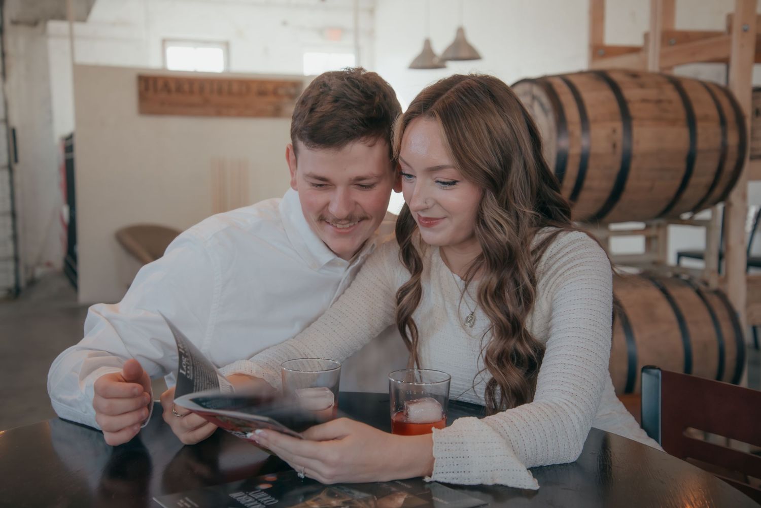 Indoor engagement photo with natural light. Kentucky lifestyle photographer captures candid love and cozy, heartfelt connection.