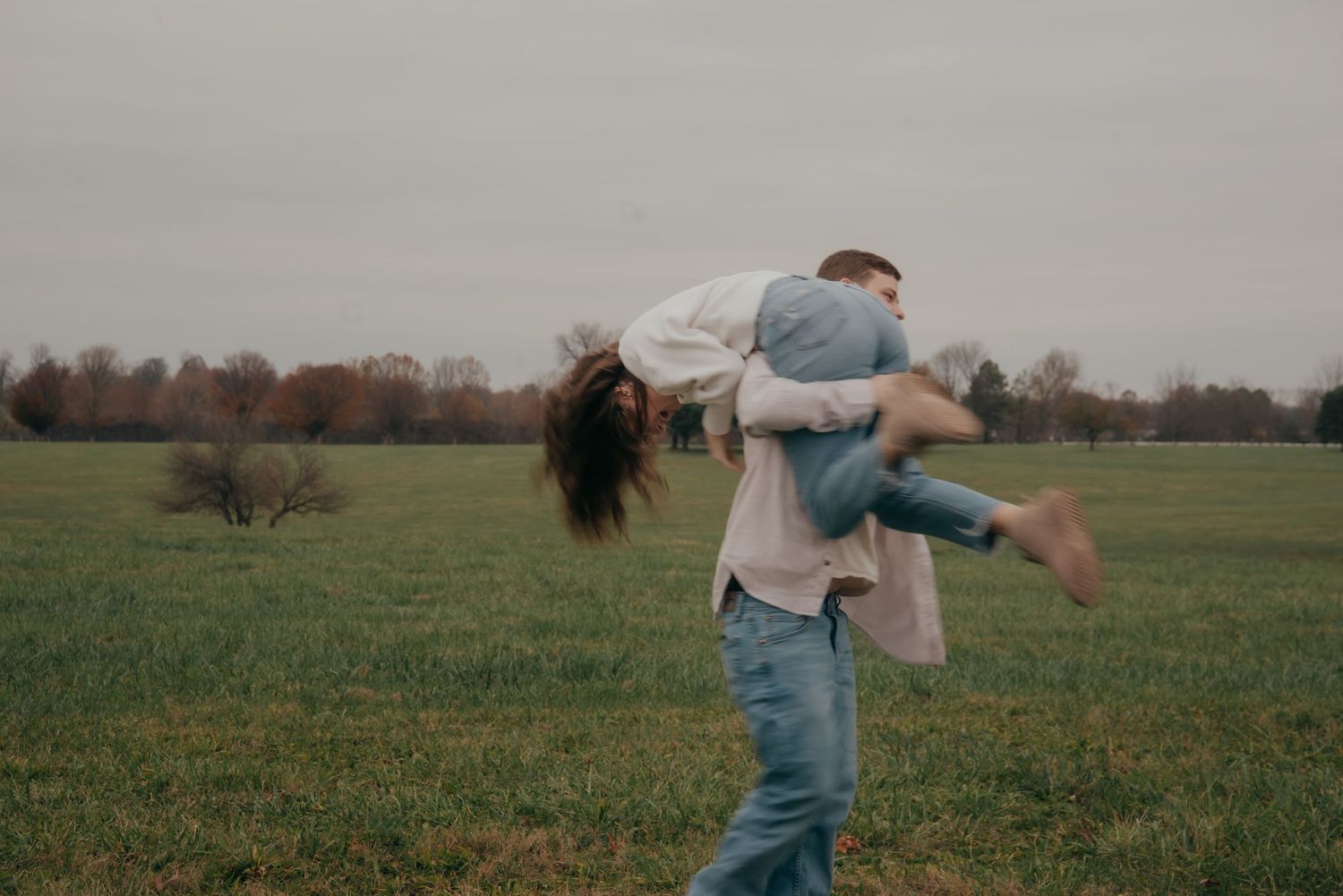 Outdoor engagement photo in natural light. Kentucky lifestyle photographer captures candid love and joyful connection.