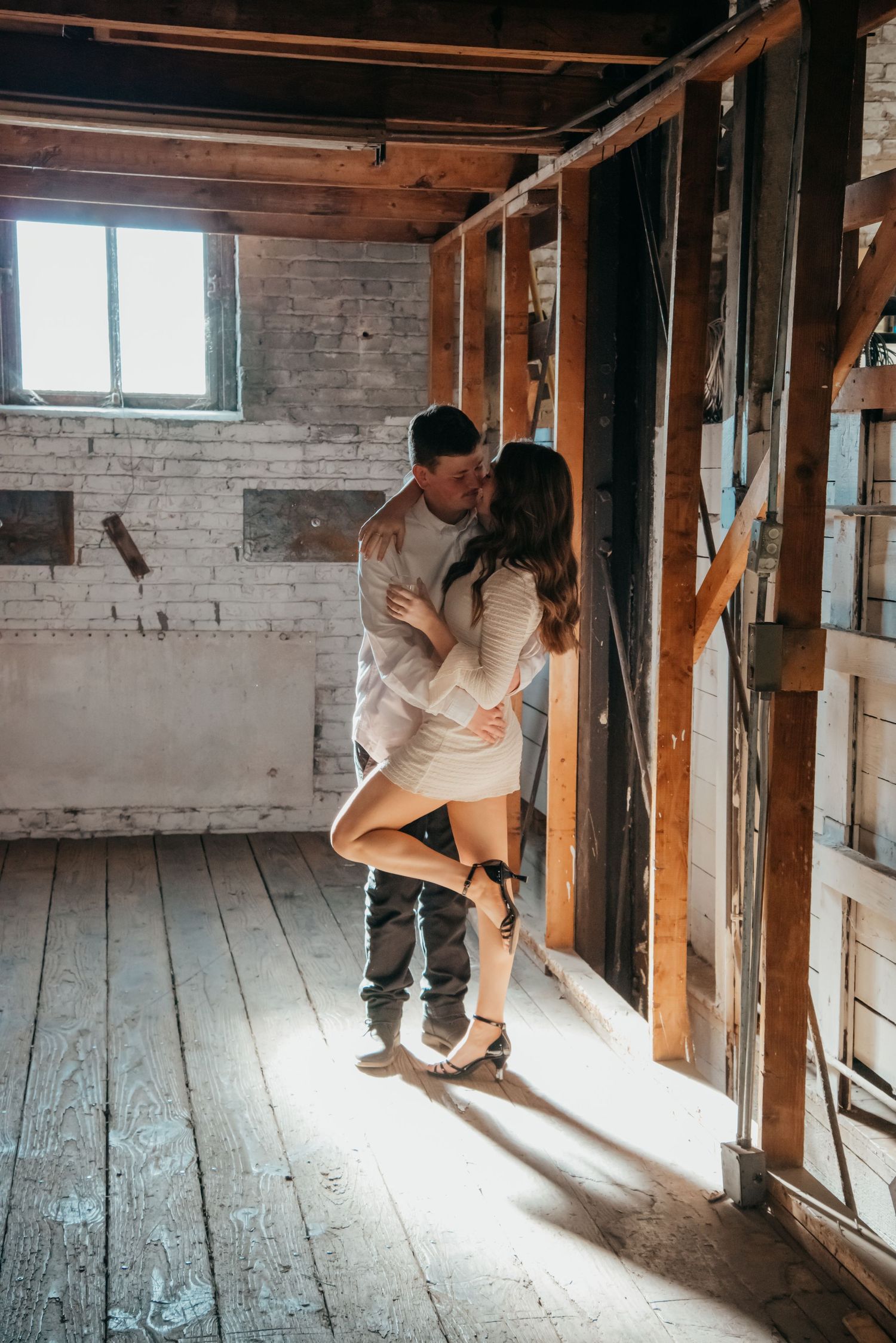 Indoor engagement photo with natural light. Kentucky lifestyle photographer captures candid love and cozy, heartfelt connection.