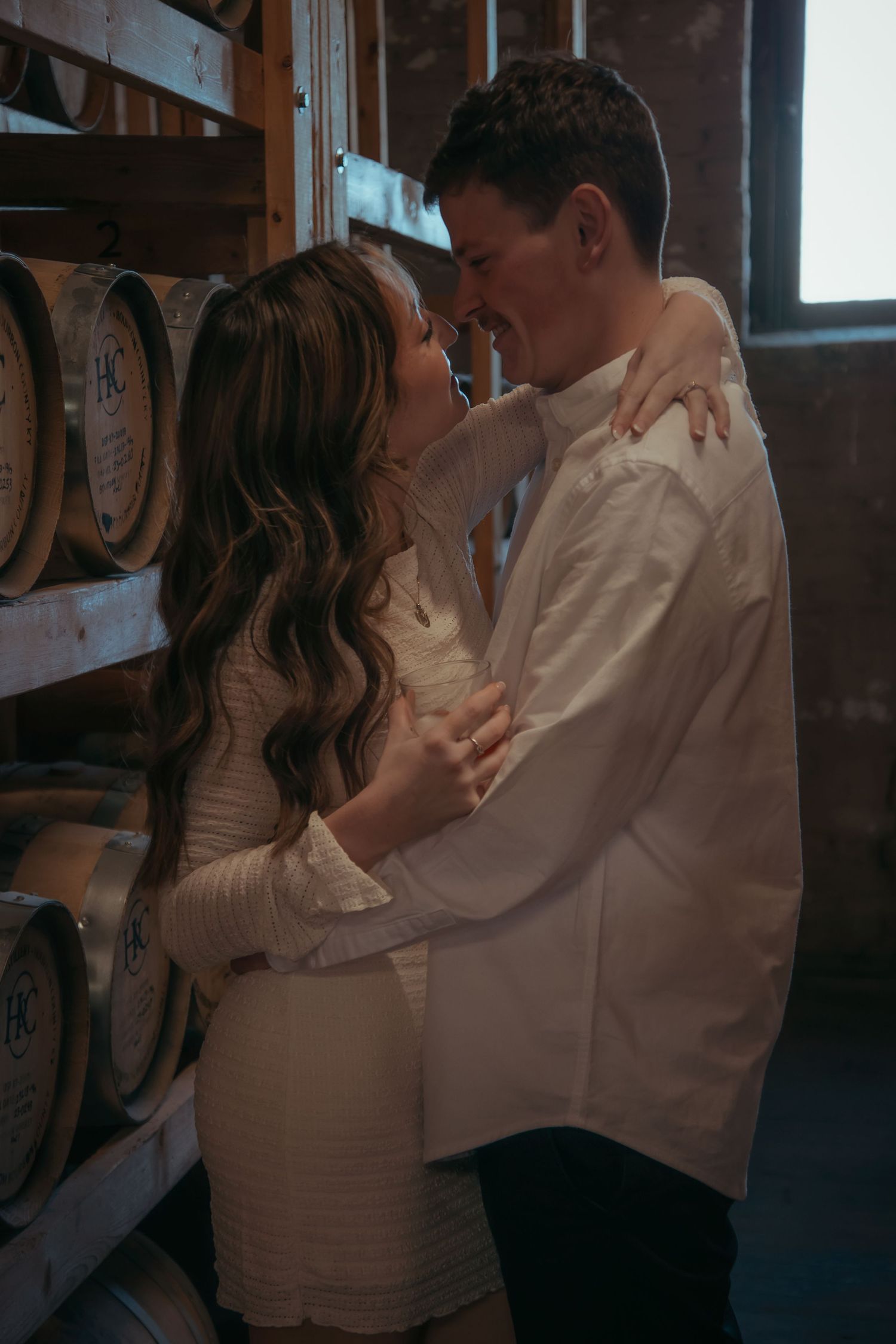 Indoor engagement photo with natural light. Kentucky lifestyle photographer captures candid love and cozy, heartfelt connection.