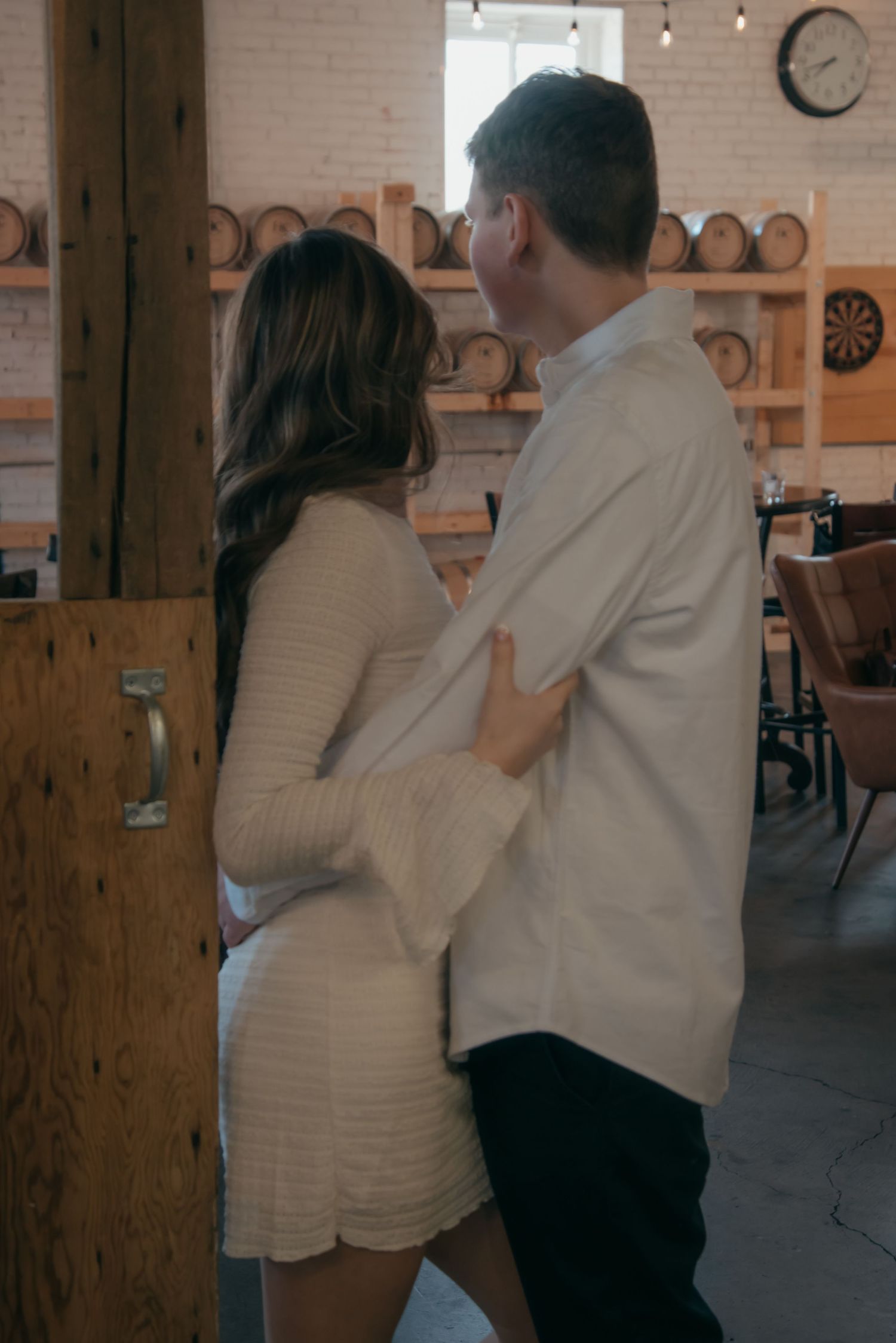 Indoor engagement photo with natural light. Kentucky lifestyle photographer captures candid love and cozy, heartfelt connection.